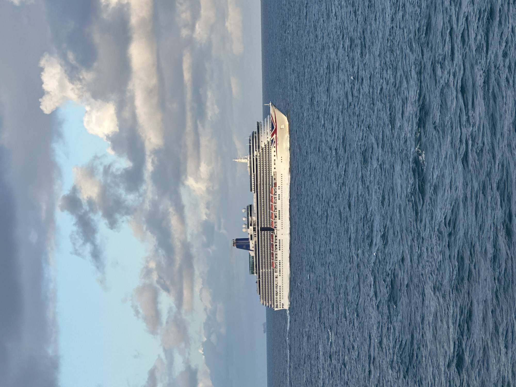 Cruise ship Arcadia at sea under cloudy skies