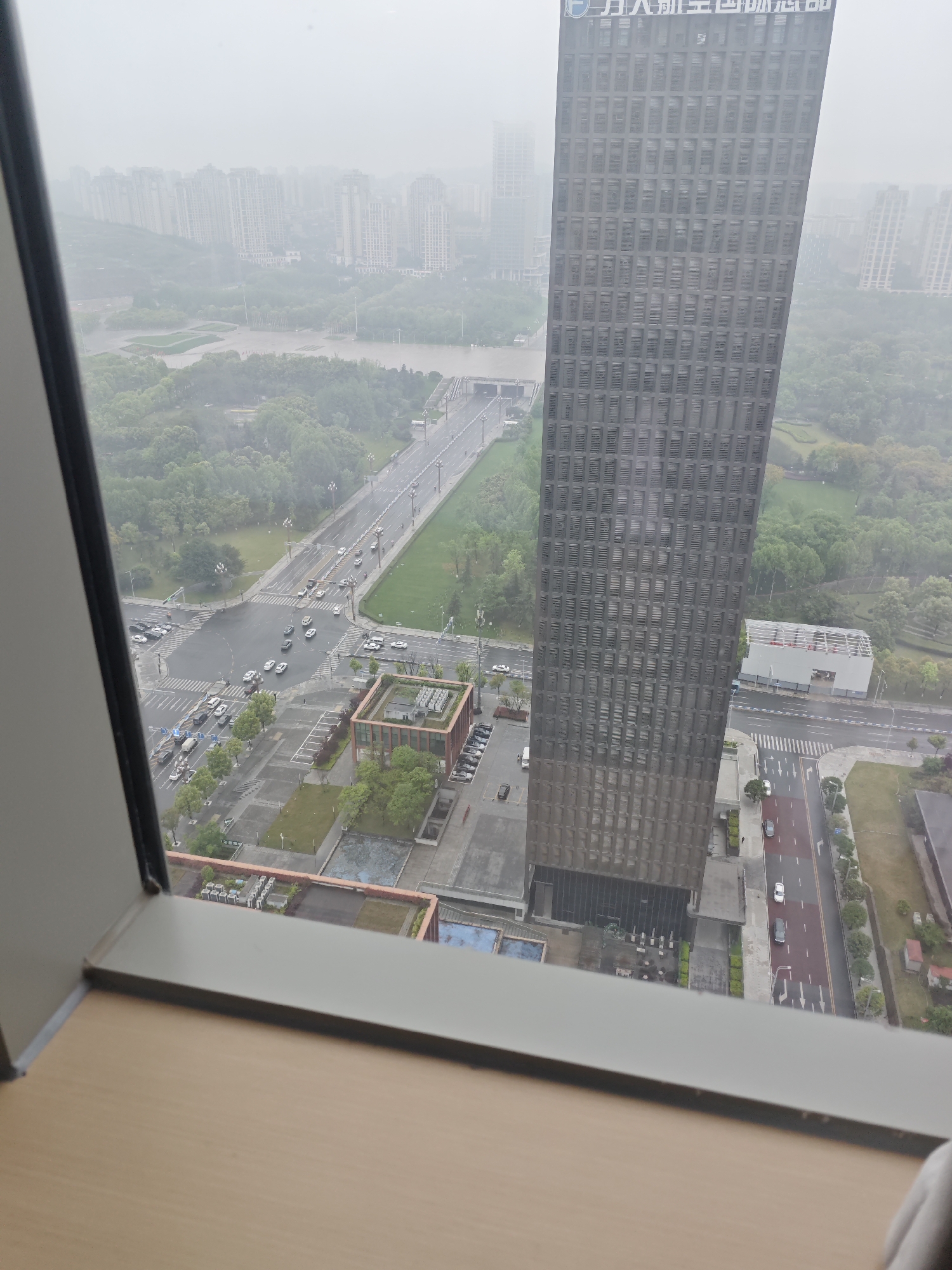 Heavy mist shrouds Liangjiang cityscape viewed from high-rise