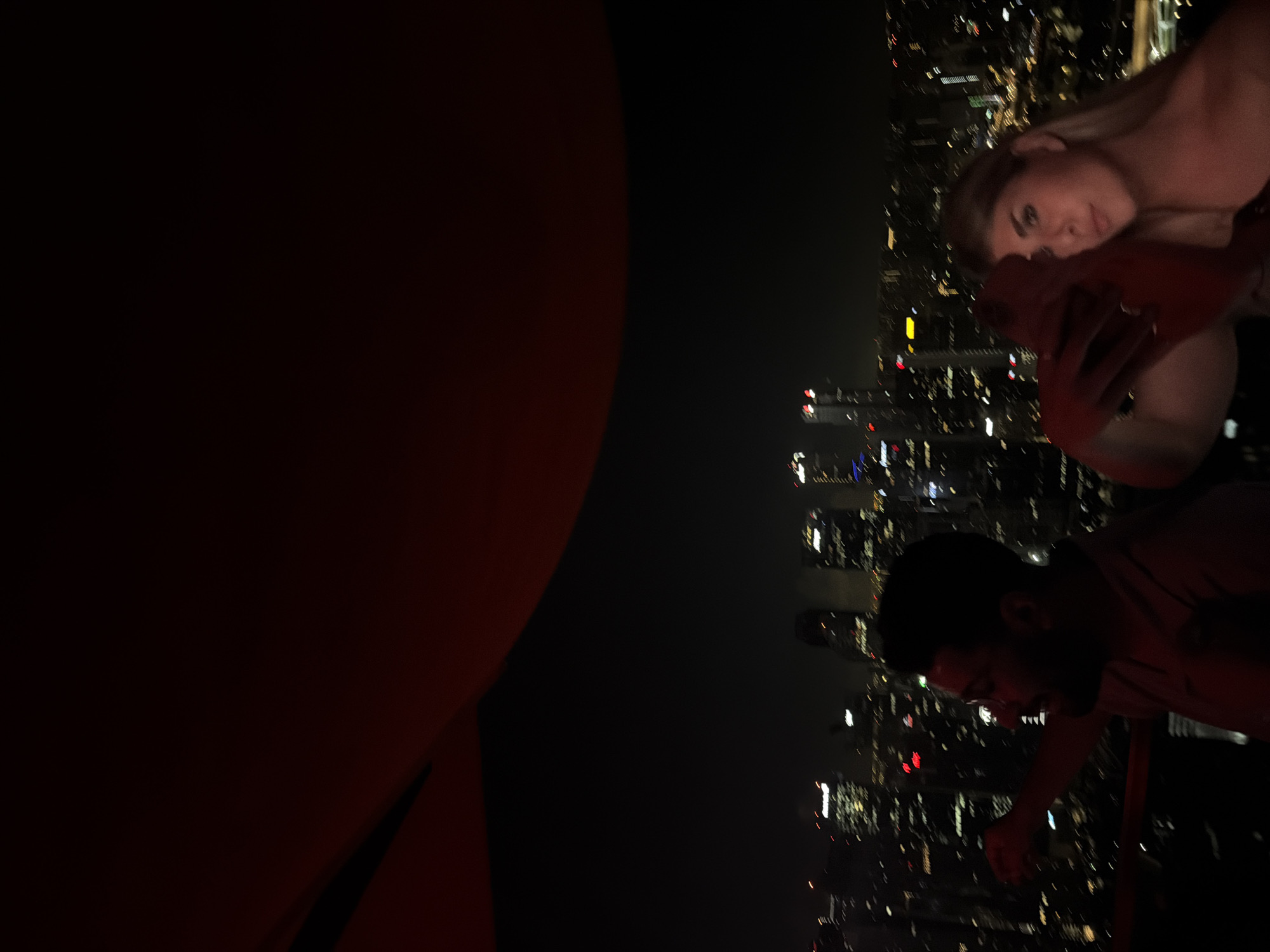 Couple enjoys Singapore skyline view from high-rise balcony