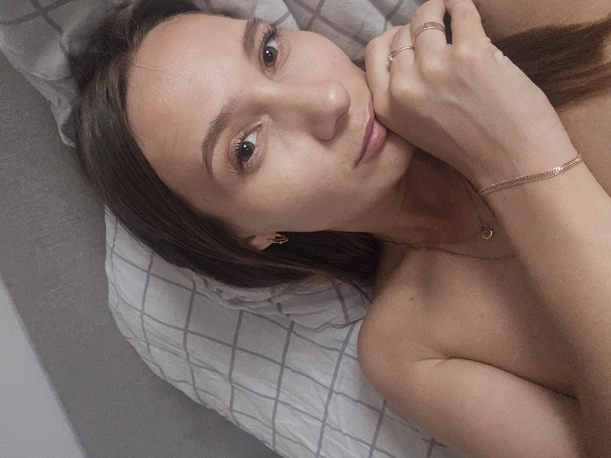 Woman resting on checkered bedding in Chaikovsky, Russia