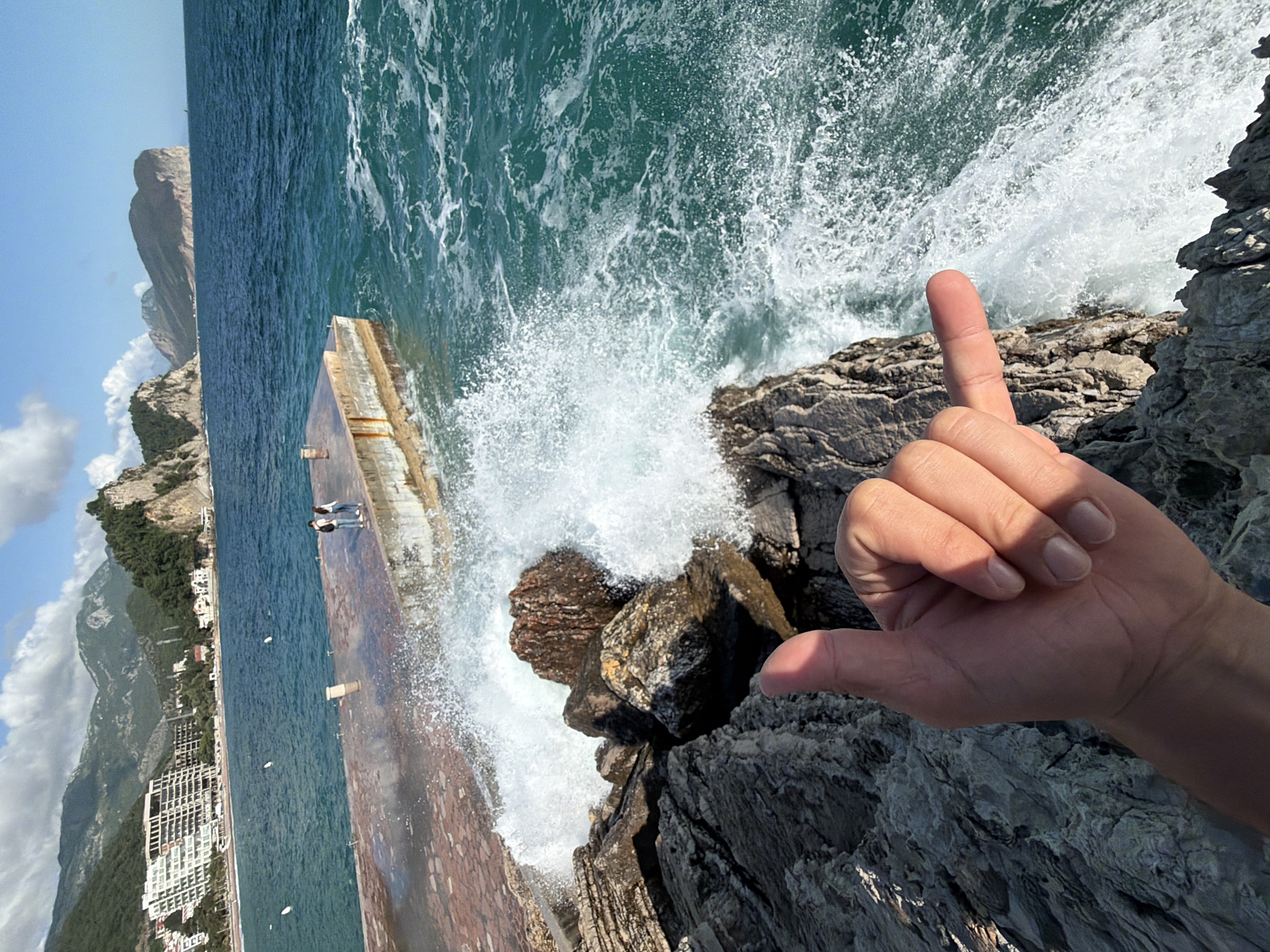Tourist documents seaside day in Petrovac, Montenegro with selfies