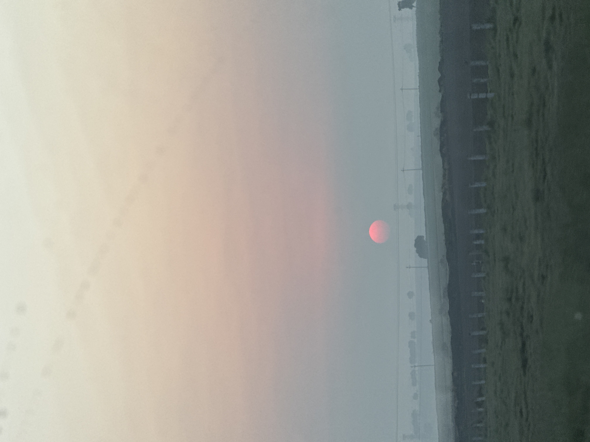 Red sun observed through hazy conditions in rural Mexico