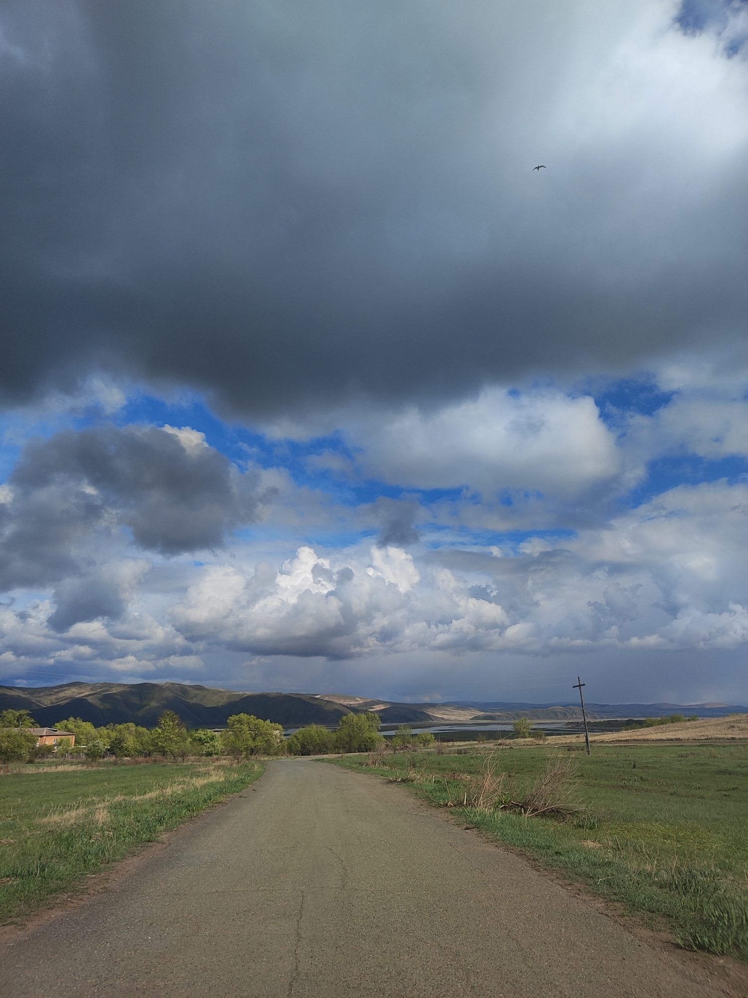 Mixed rural and urban scenes documented under dramatic skies
