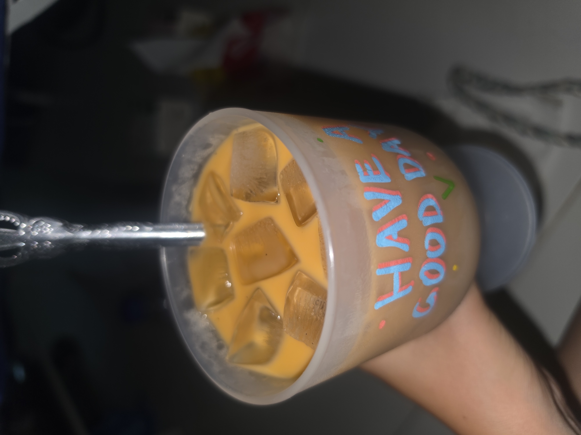 Person enjoys decorated iced beverages with motivational messages
