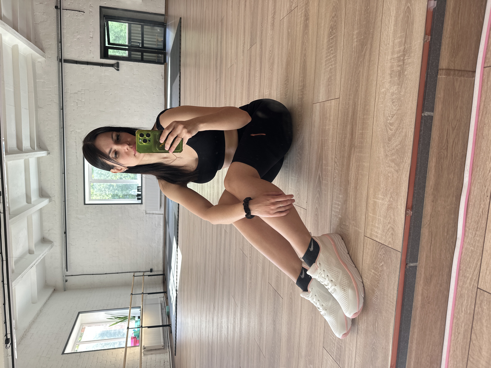 Woman in athletic wear seated in dance studio