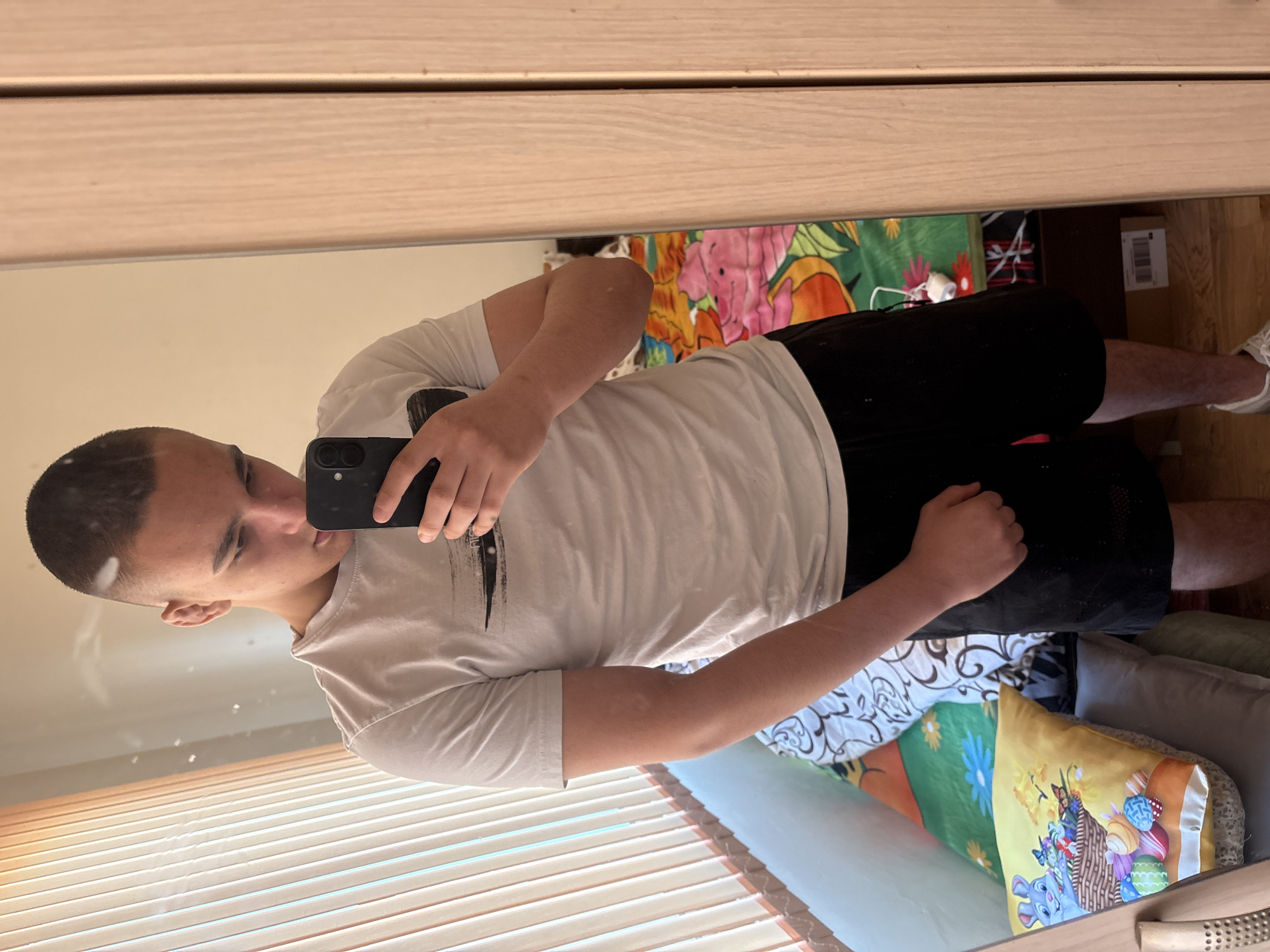 Young man takes mirror selfie in Asenovgrad bedroom