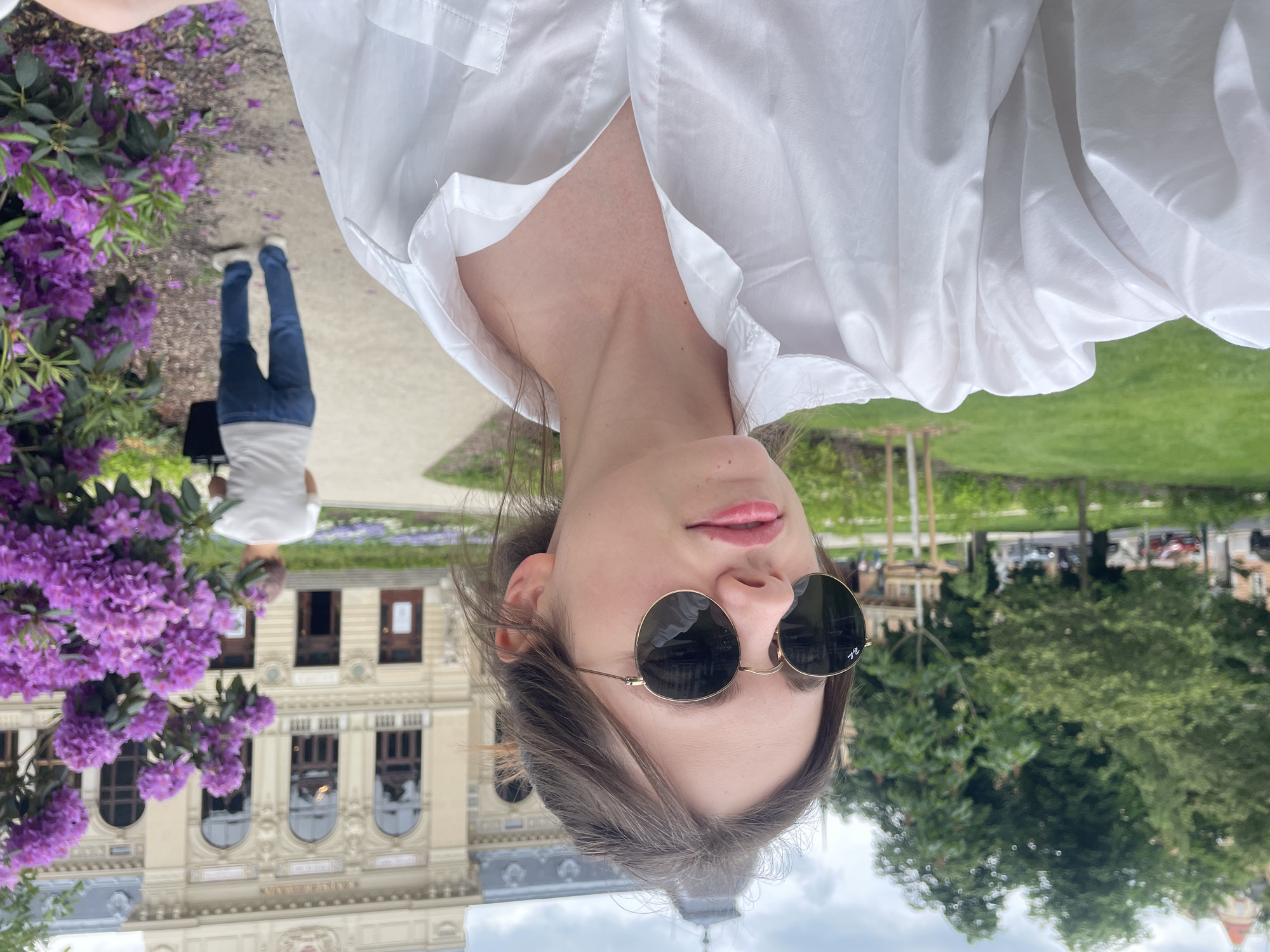 Tourist captures selfies amid blooming rhododendrons at Karlovy Vary spa