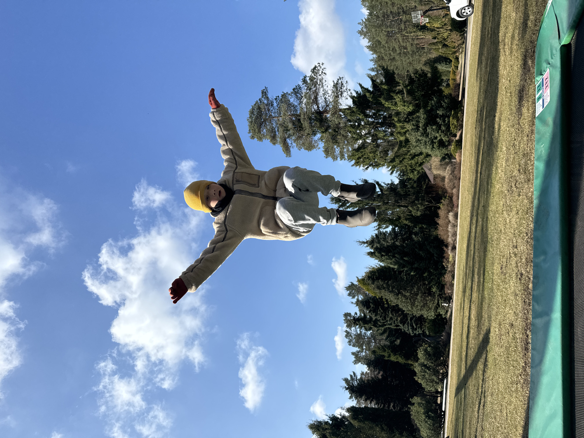 Child captured mid-air jumping in Stapriņi, Latvia