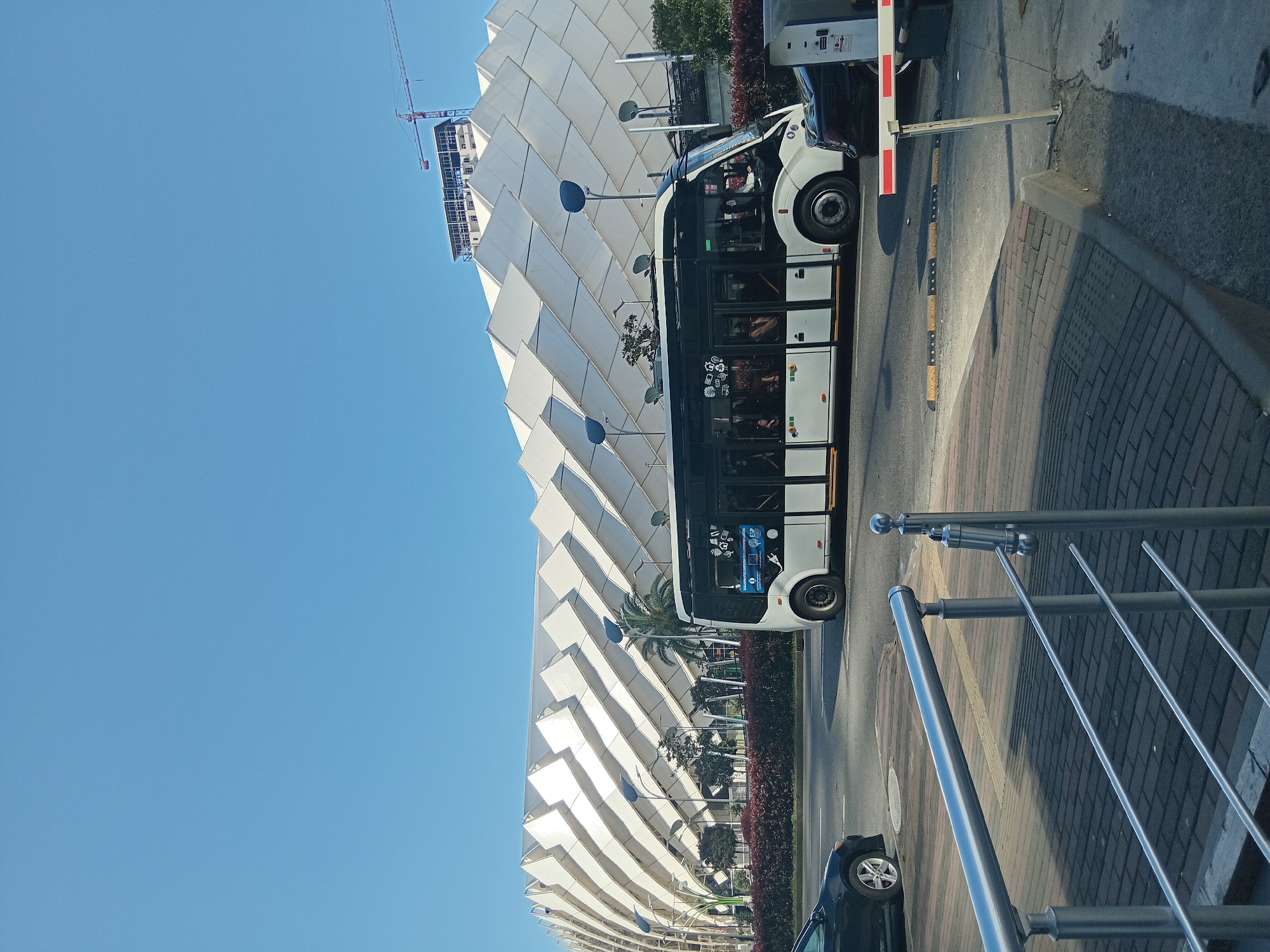 City bus stops near modern triangular building in Batumi