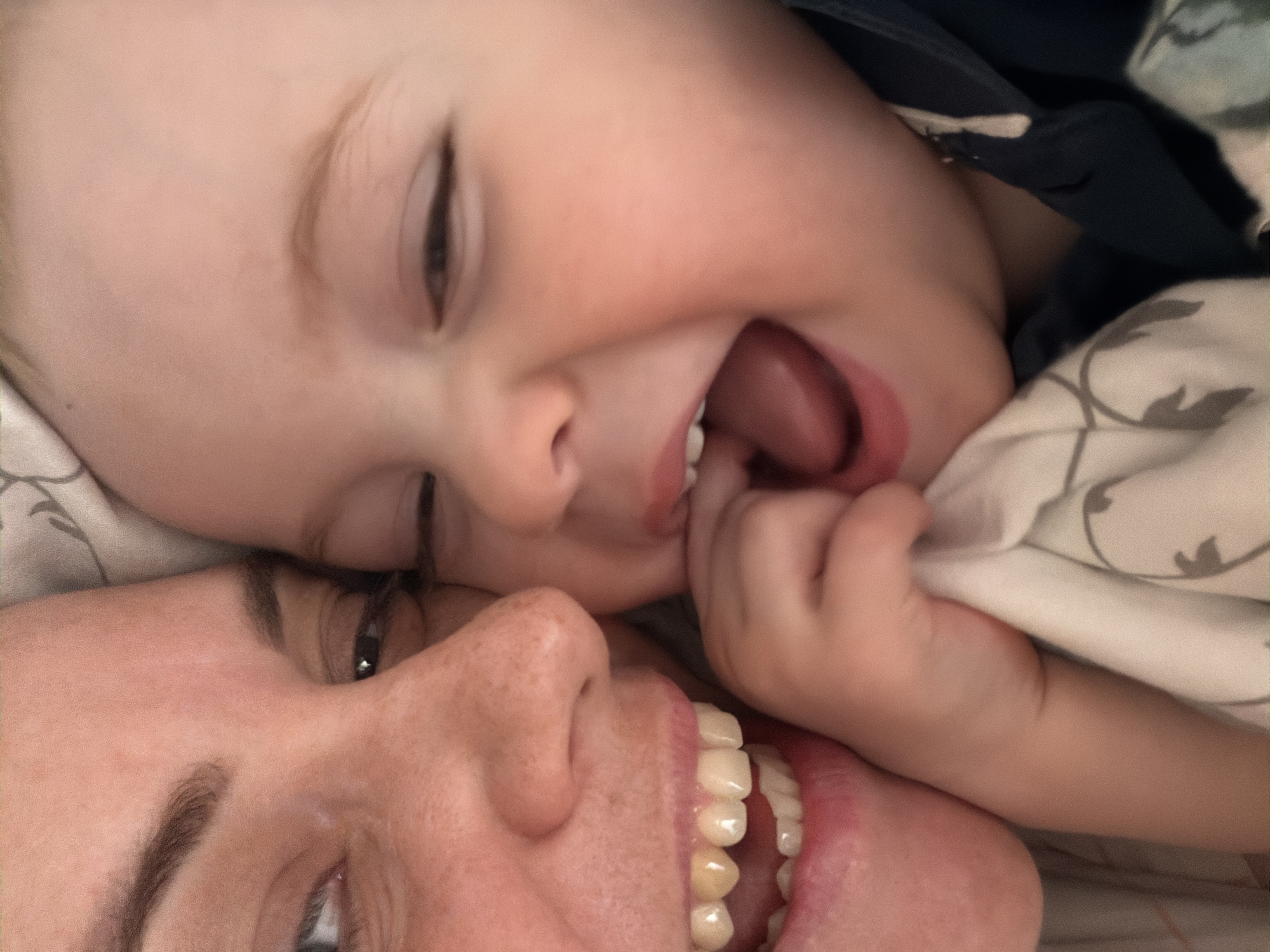 Baby plays with toys alongside chihuahua in Votkinsk bedroom