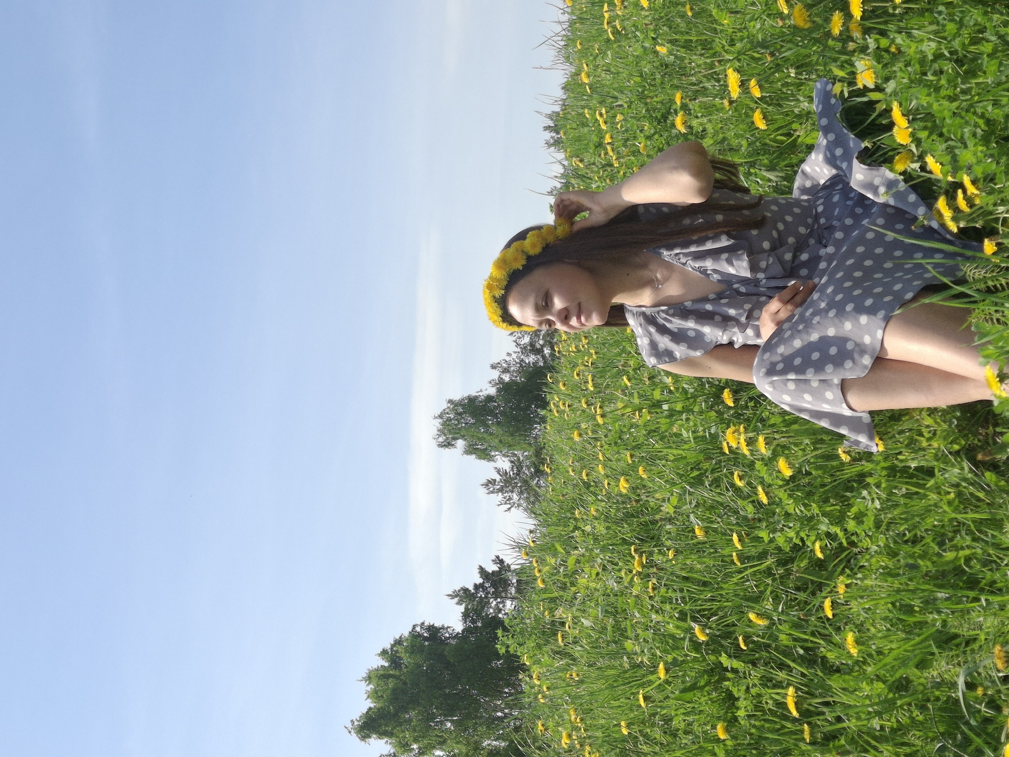 Woman poses with dandelions in Russian field photoshoot