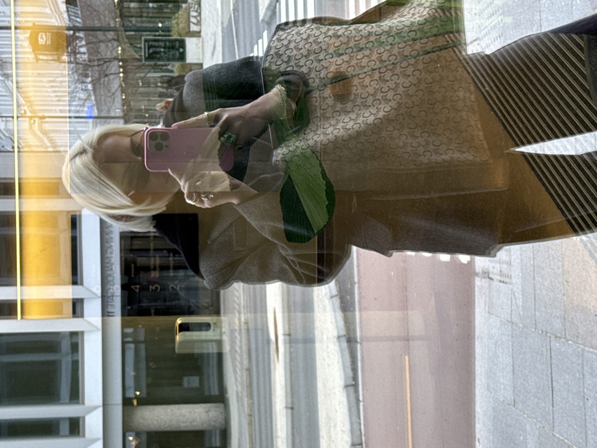 Blonde woman films fashion content with Celine bag in Oslo