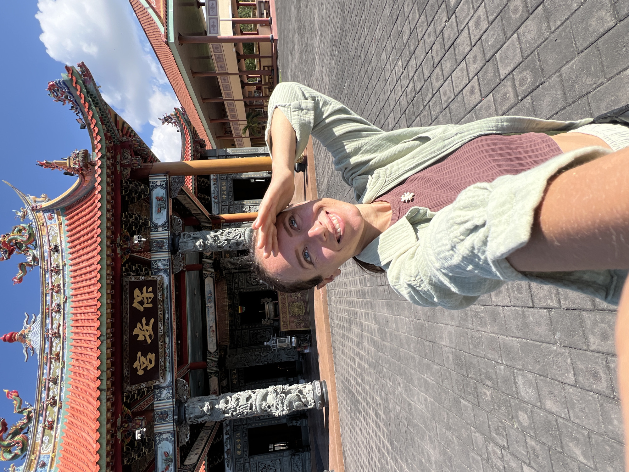 Tourist visits ornate Buddhist temple complex in Denpasar, Indonesia