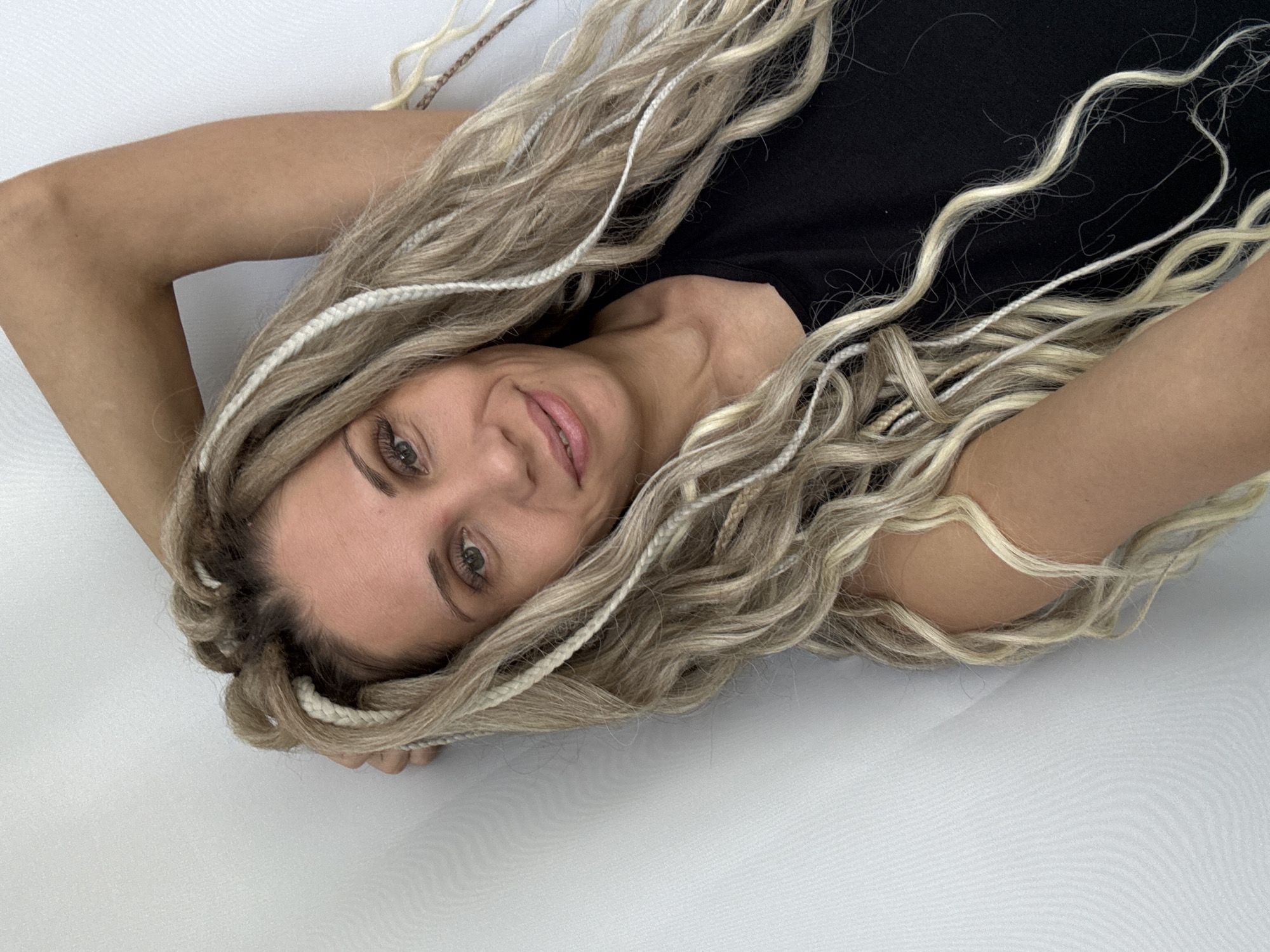Woman with braided hair observed on white surface in Rusanovo