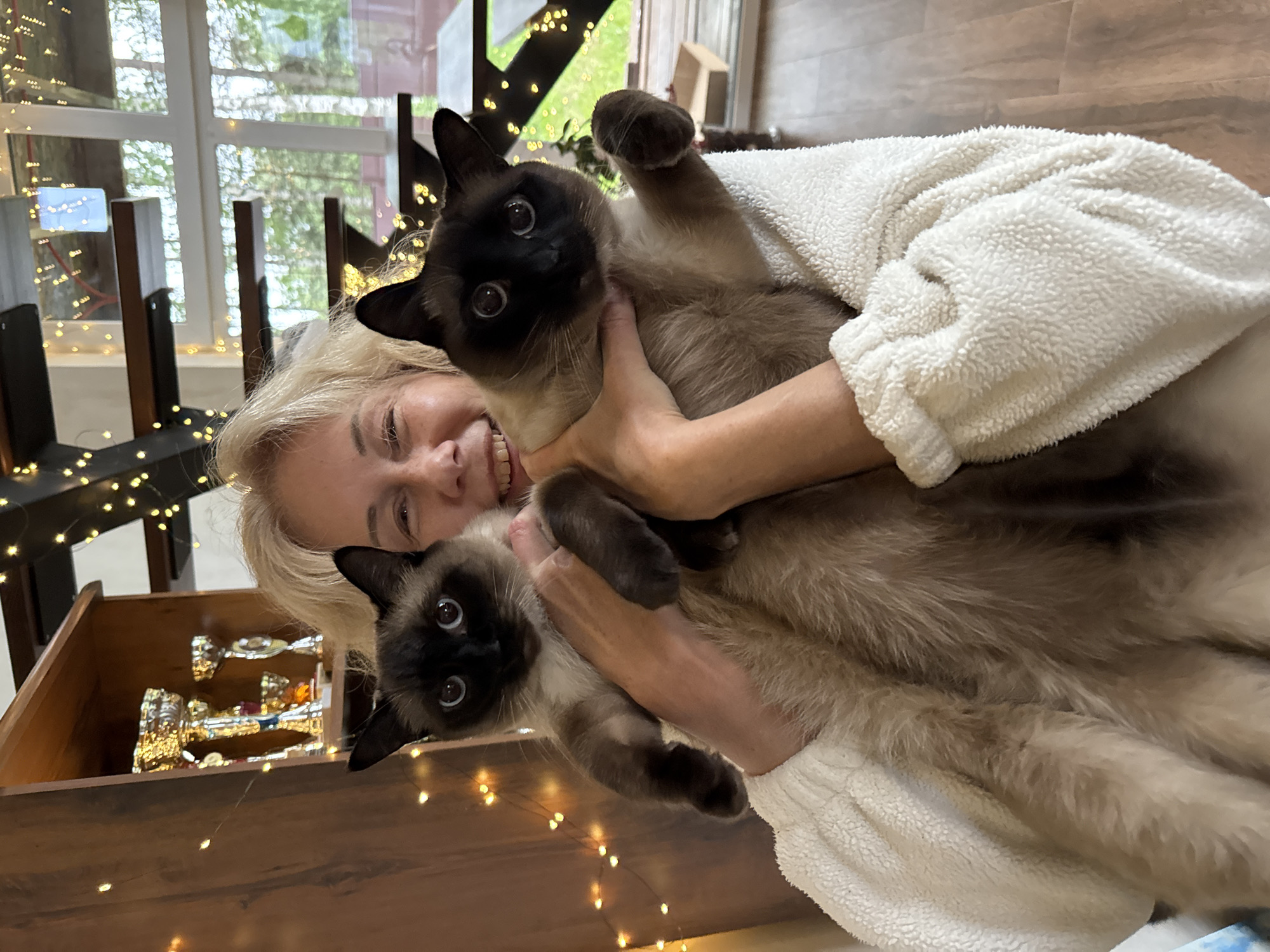 Spring day documented: woman with cats, blooming gardens in Russia