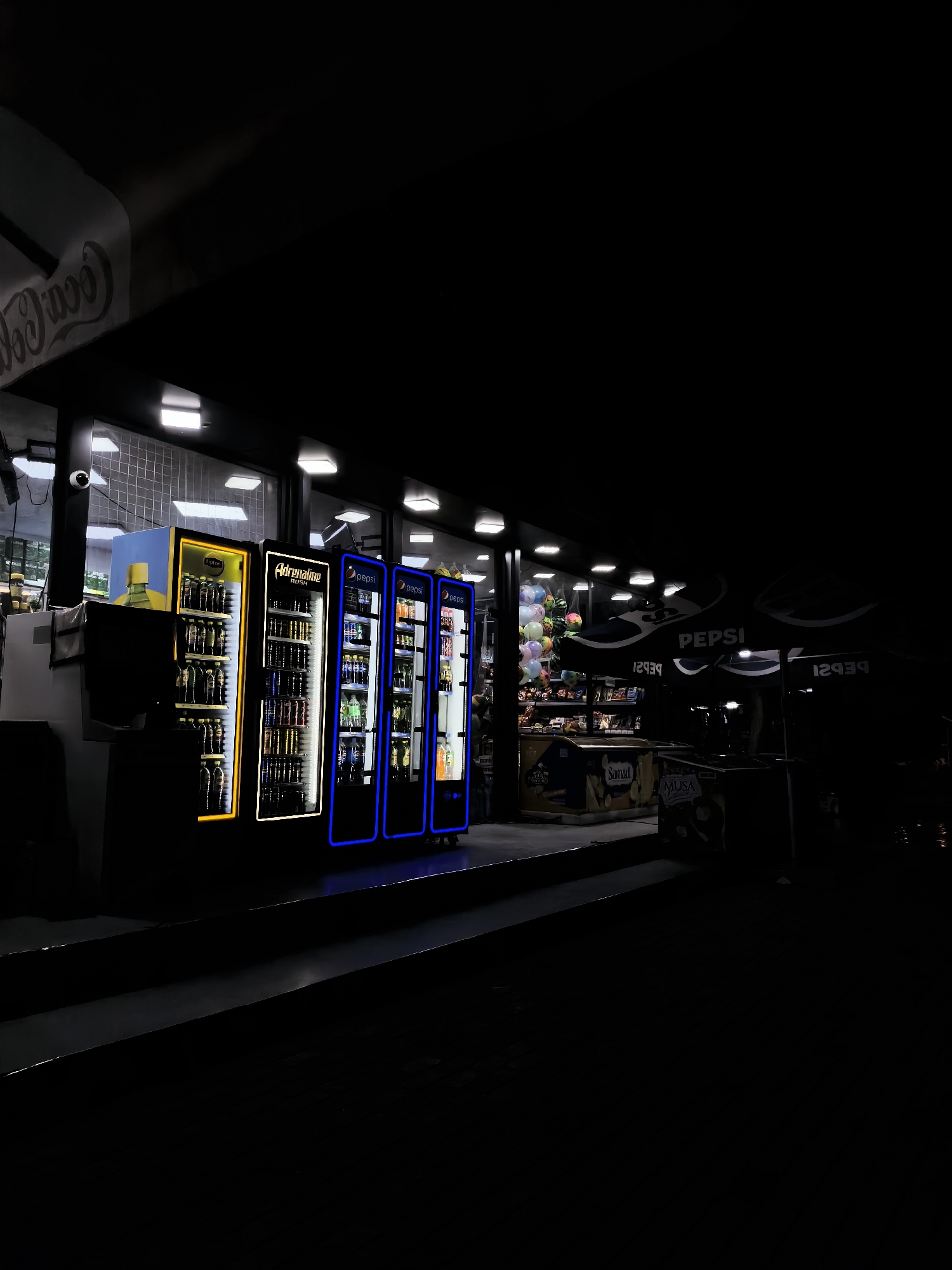 Fergana City's lit-up commercial strip on a summer evening