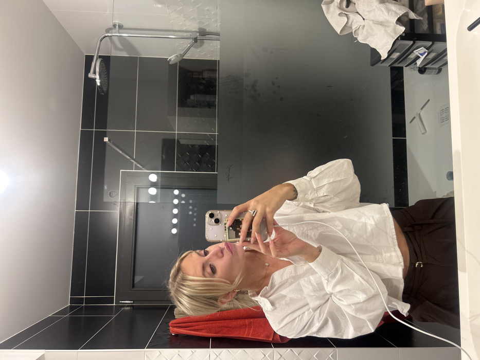 Woman takes bathroom mirror selfies in Chambœuf, France
