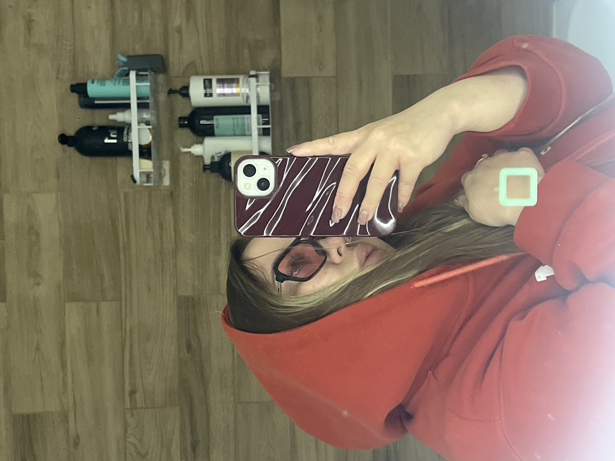 Person takes mirror selfies in red hoodie in Krasnodar