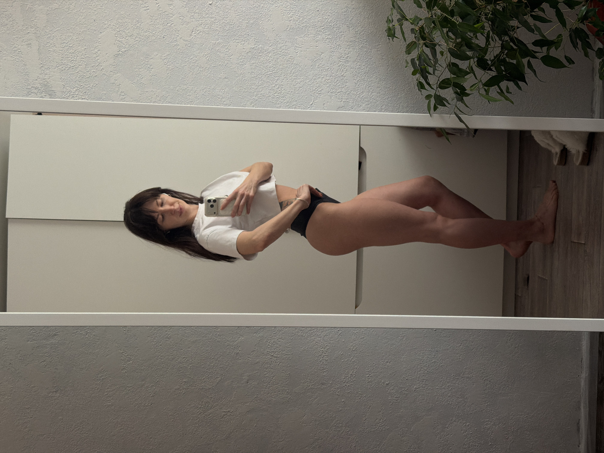 Woman takes mirror selfies in Perm, Russia indoor location