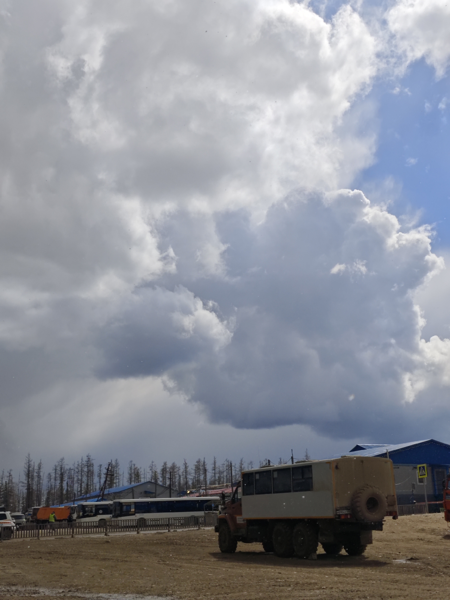 Rural Russian scenes captured: trucks, forests, cloudy skies, resting dog