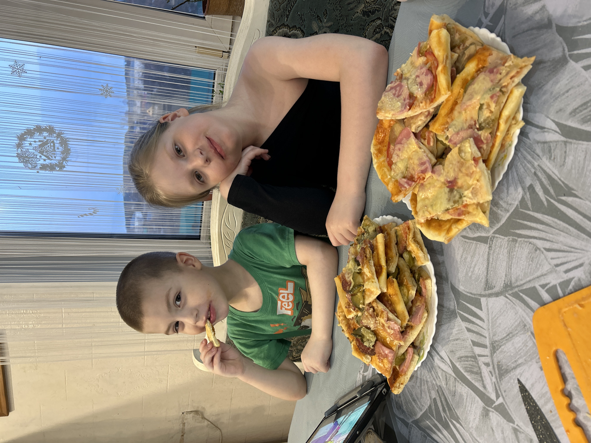 Family makes homemade pizza together in Russian village
