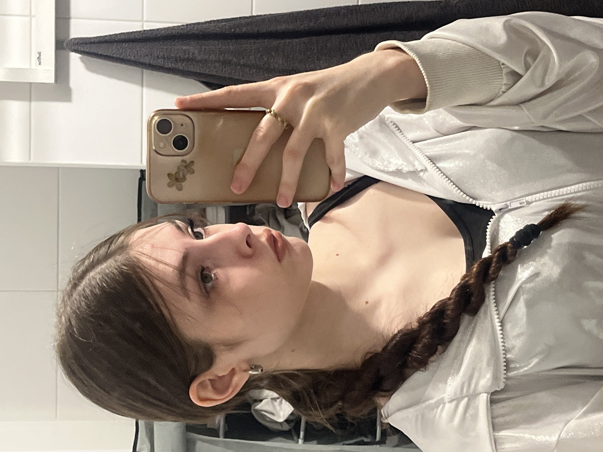 Young person takes mirror selfies in bathroom early morning