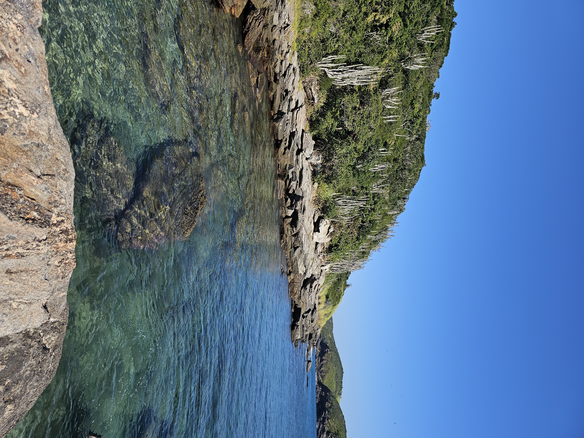 Man fishes from cliff in Armação dos Búzios