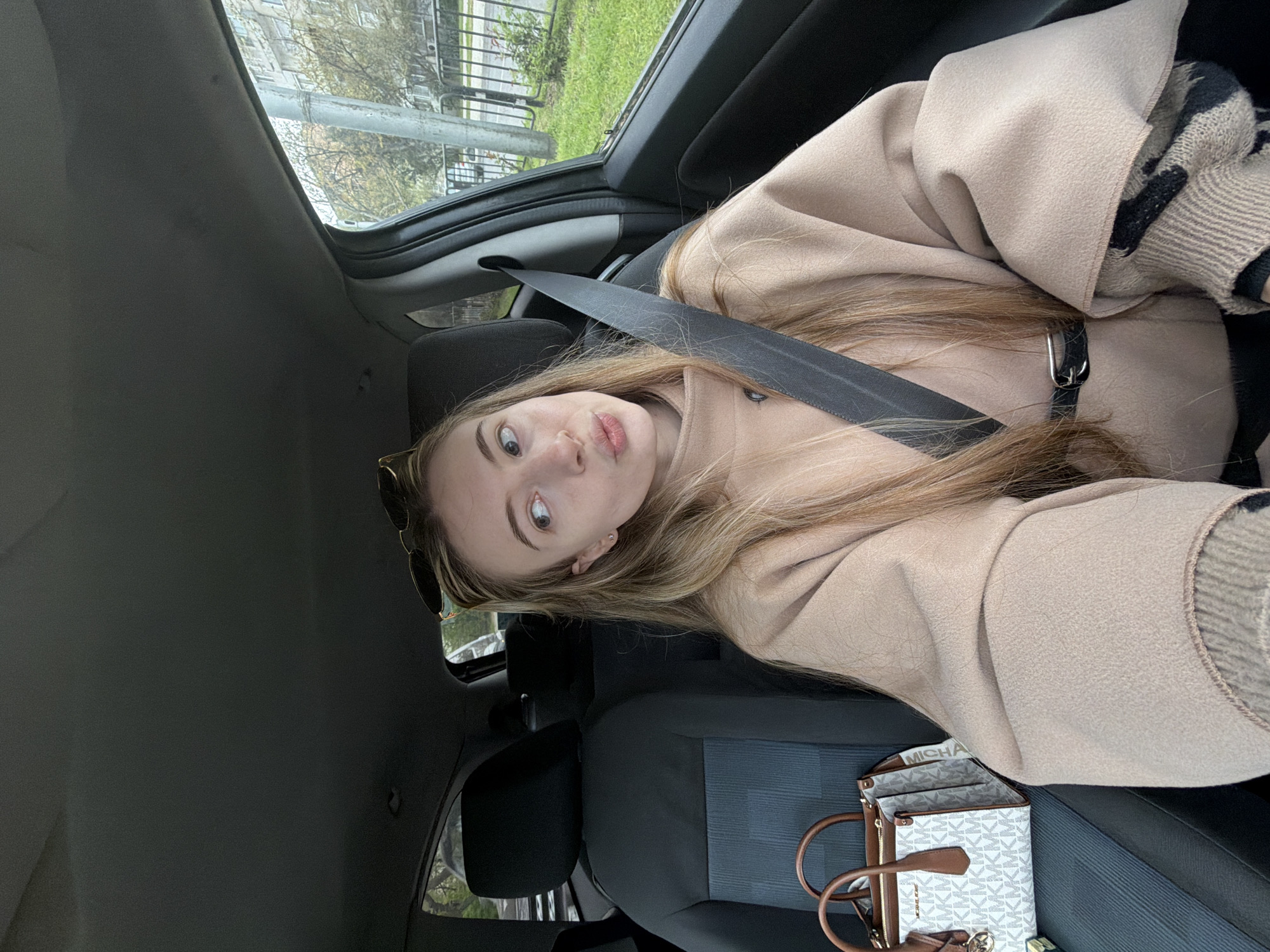 Woman in beige coat photographed in car, Plovdiv