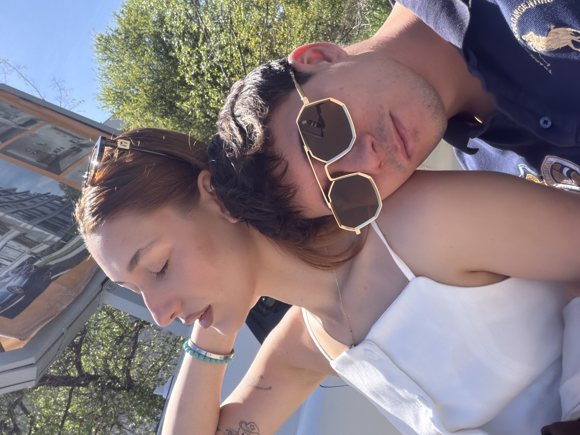 Couple takes selfies on Sofia sidewalk during midday outing