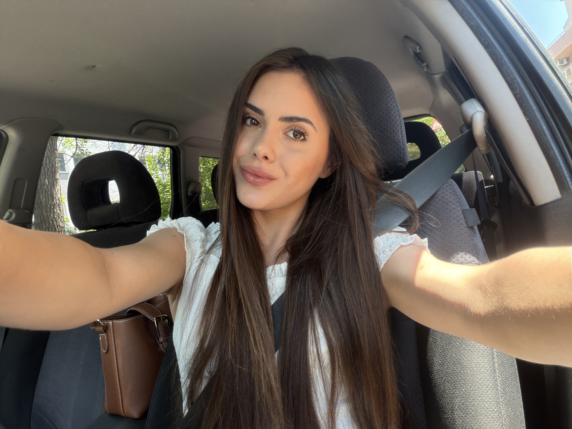 Woman takes selfies in car during morning in Burgas