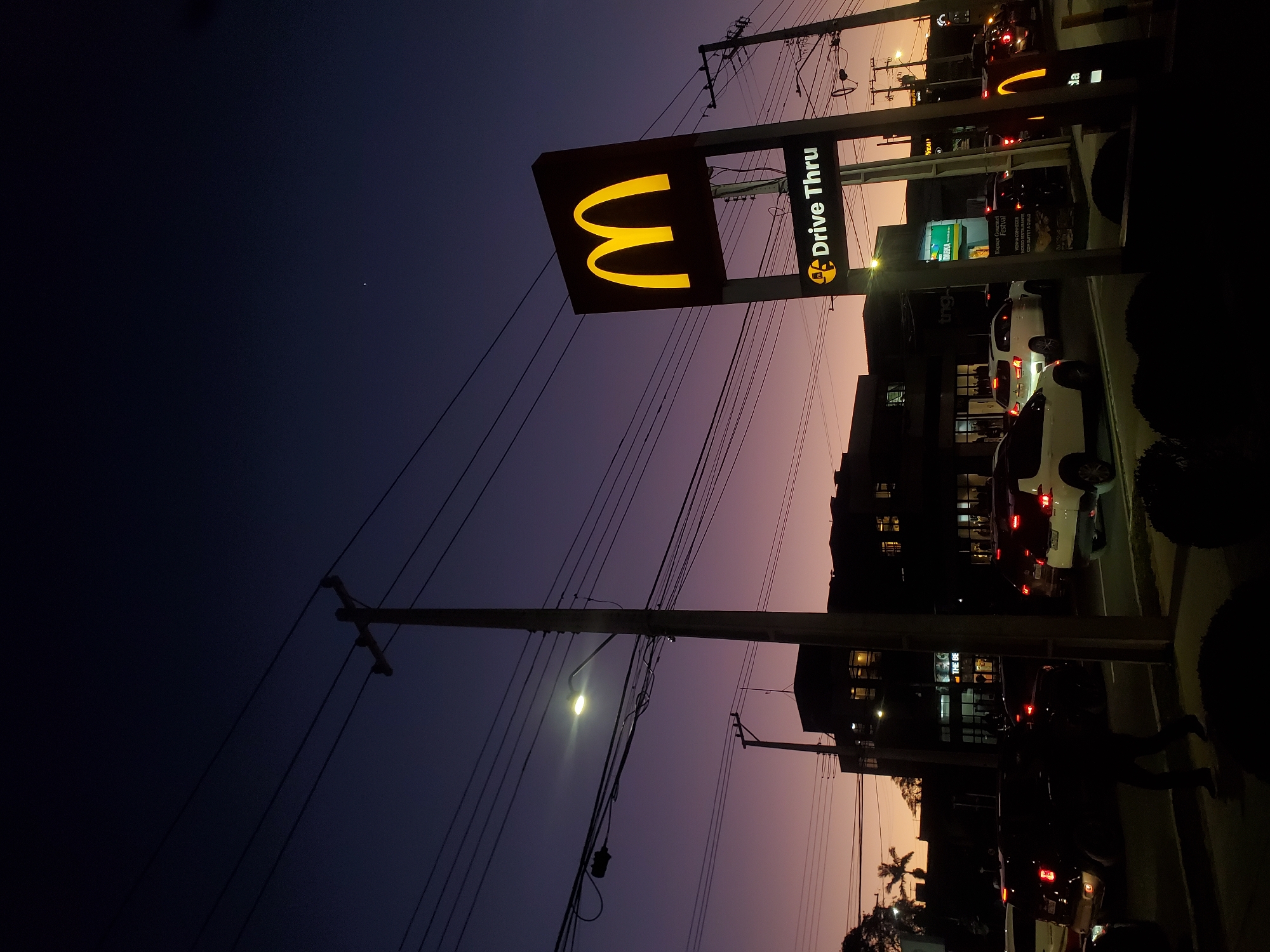 McDonald's Drive Thru sign glowing at dusk in Curitiba