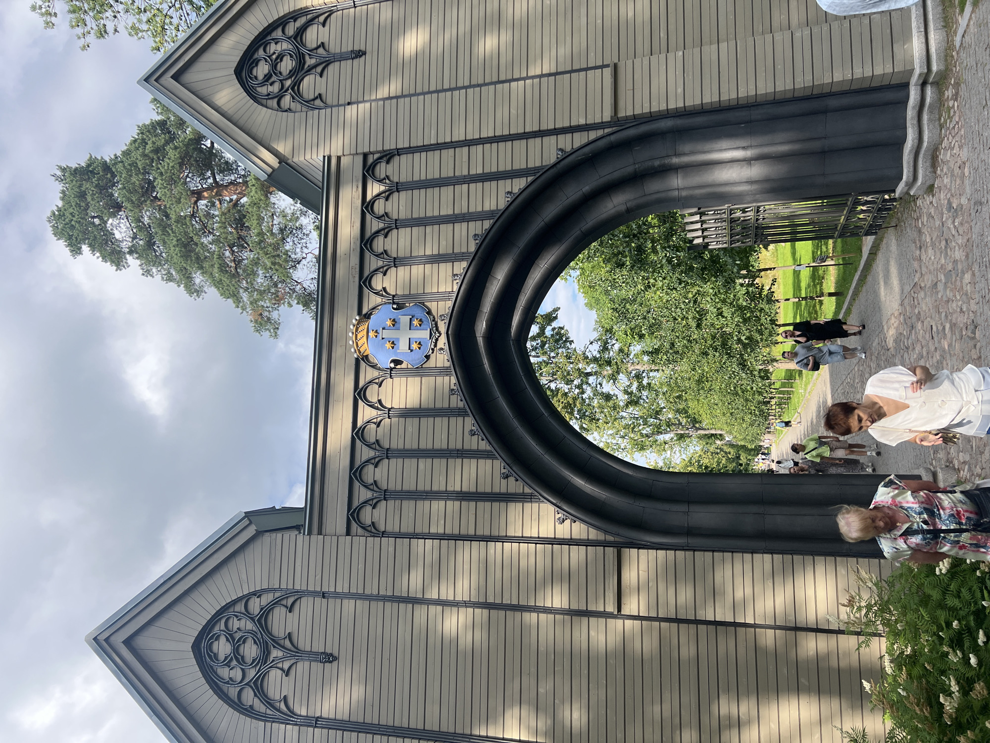 Vyborg street-level: castle gate and a neon-lit shopfront