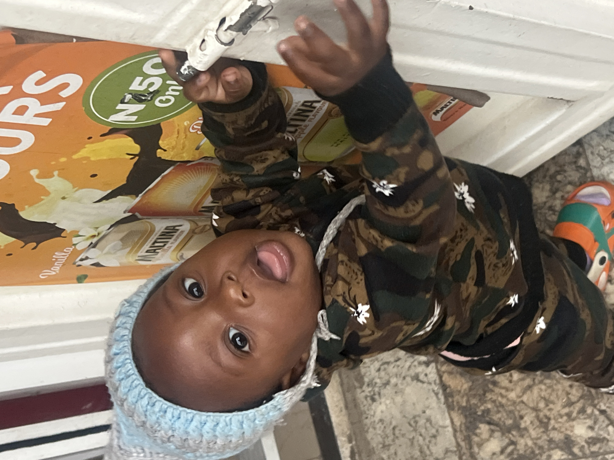Toddler's playful moments captured indoors in Gura Top, Nigeria