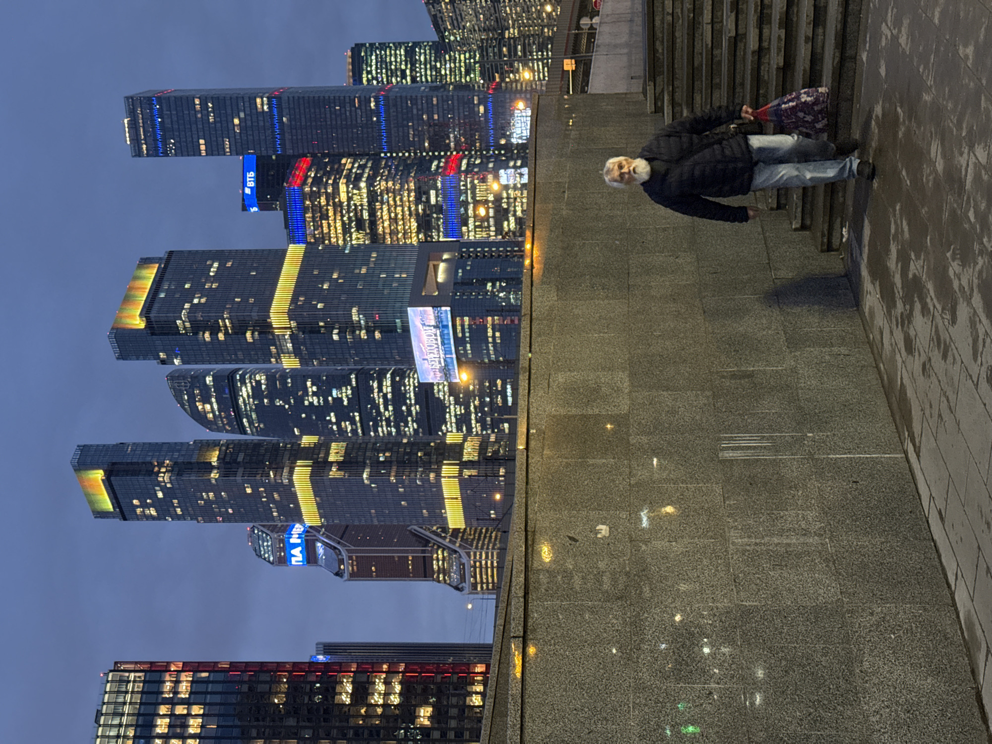 Man photographed on stairs with Moscow skyline backdrop