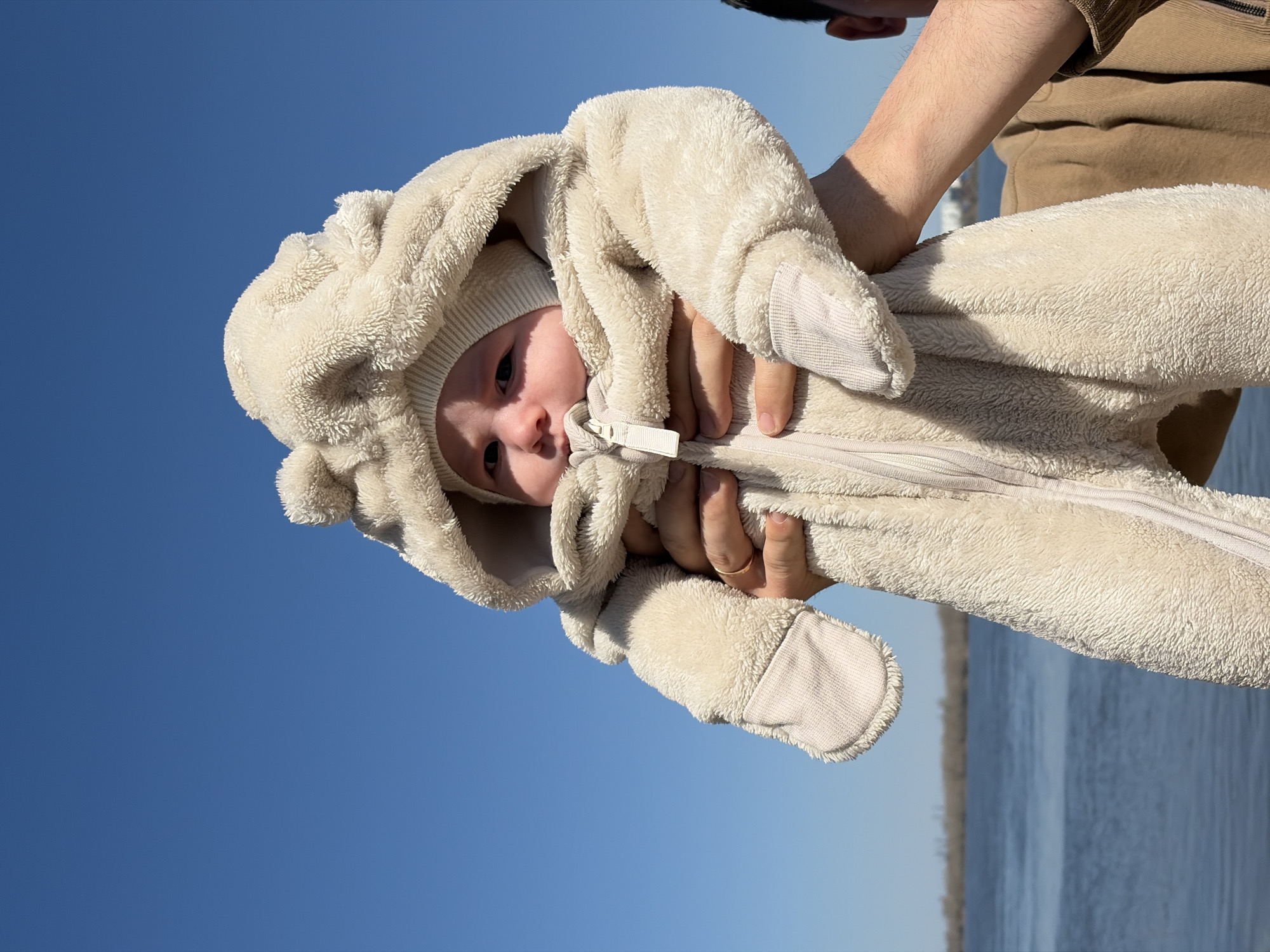 Friends enjoy sunny spring day by water in Noviy