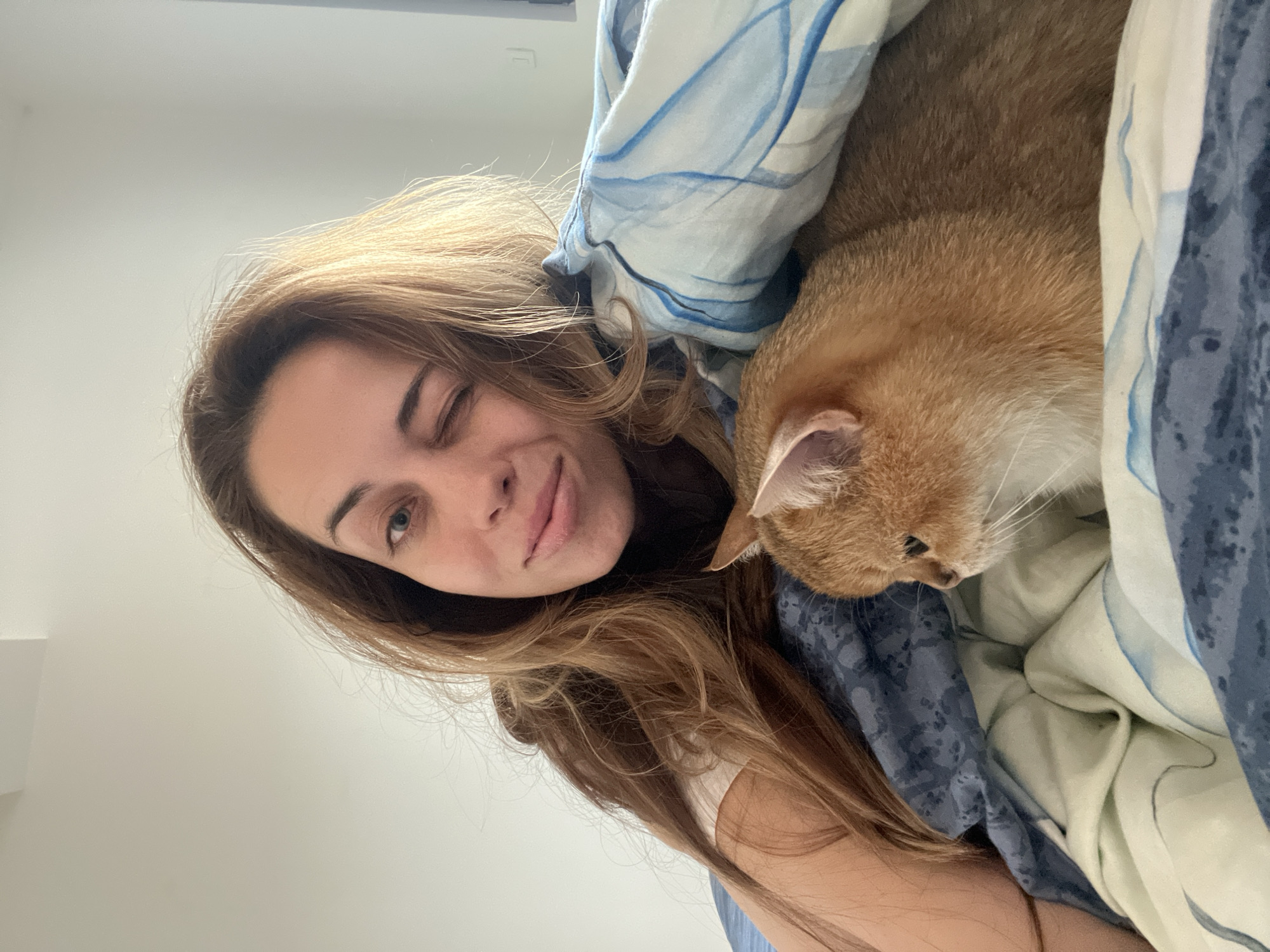 Woman shares morning moment with cat in Montenegro bedroom