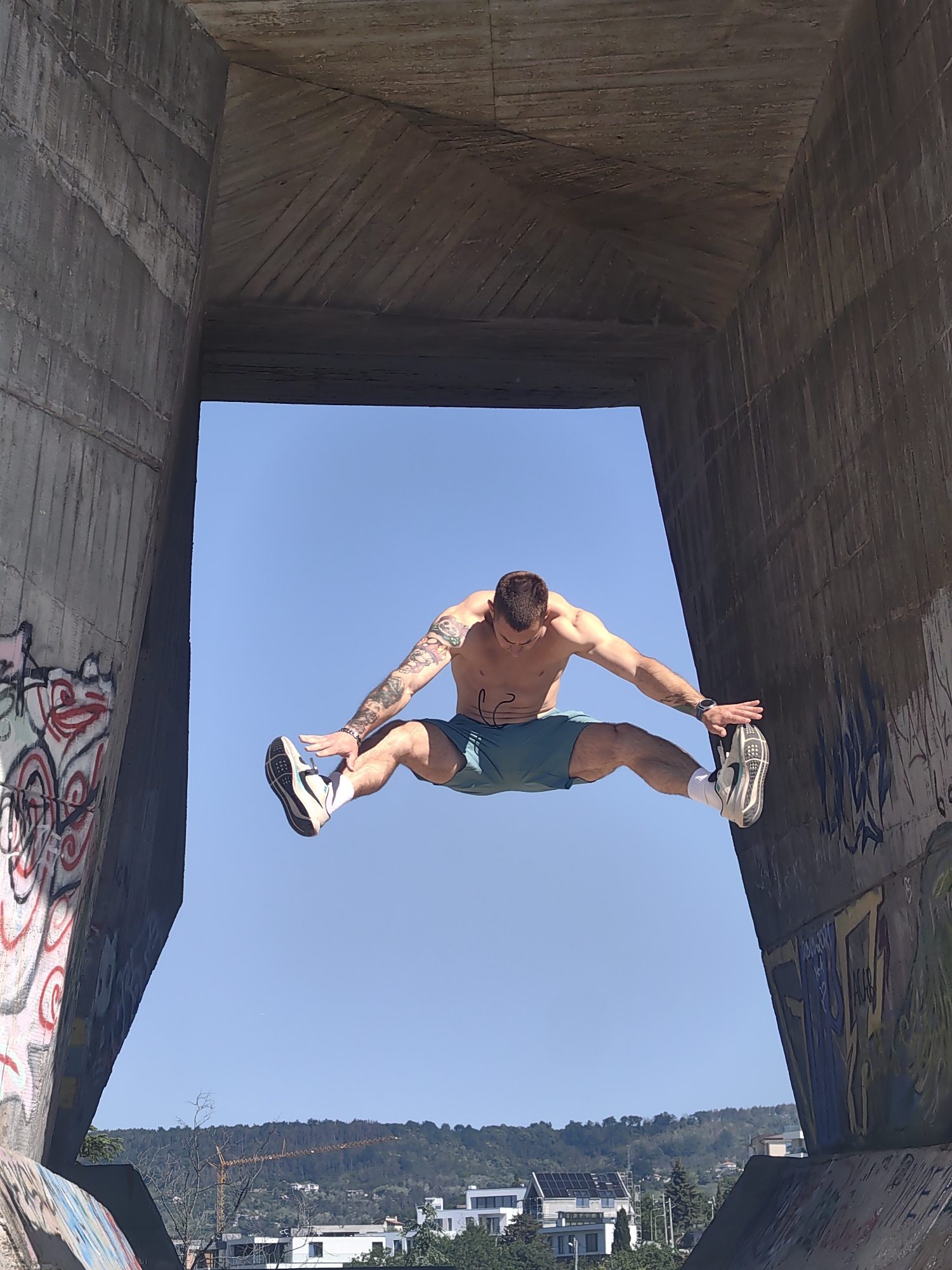 Acrobat performs stunts at graffitied concrete structure in Varna