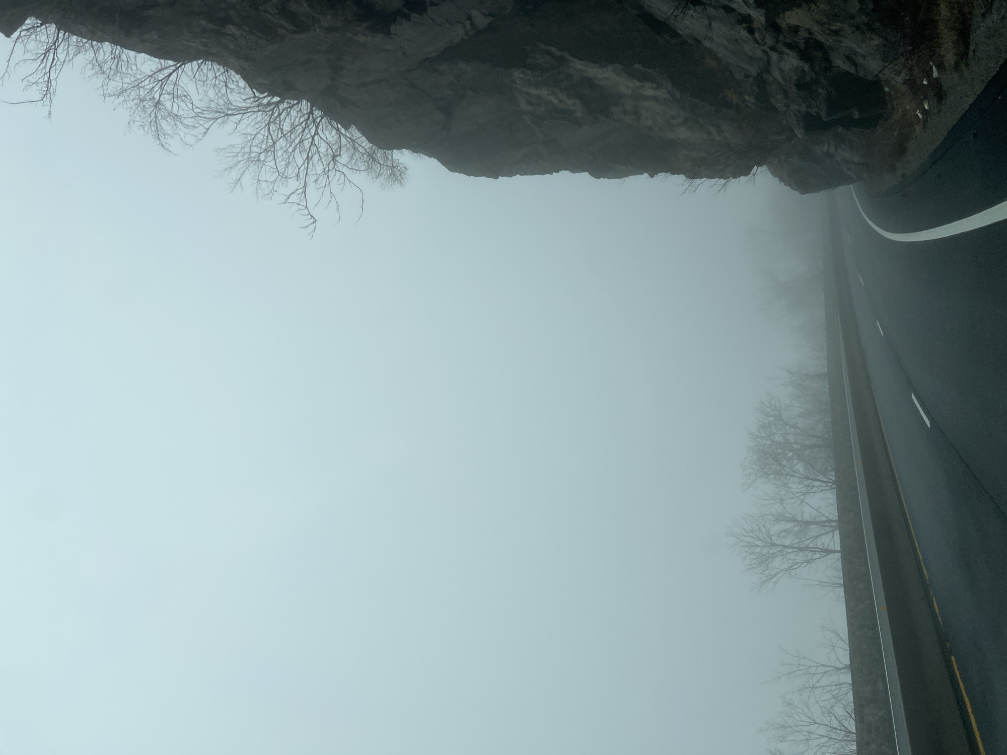 Dense fog blankets West Point road amid rocky cliffs