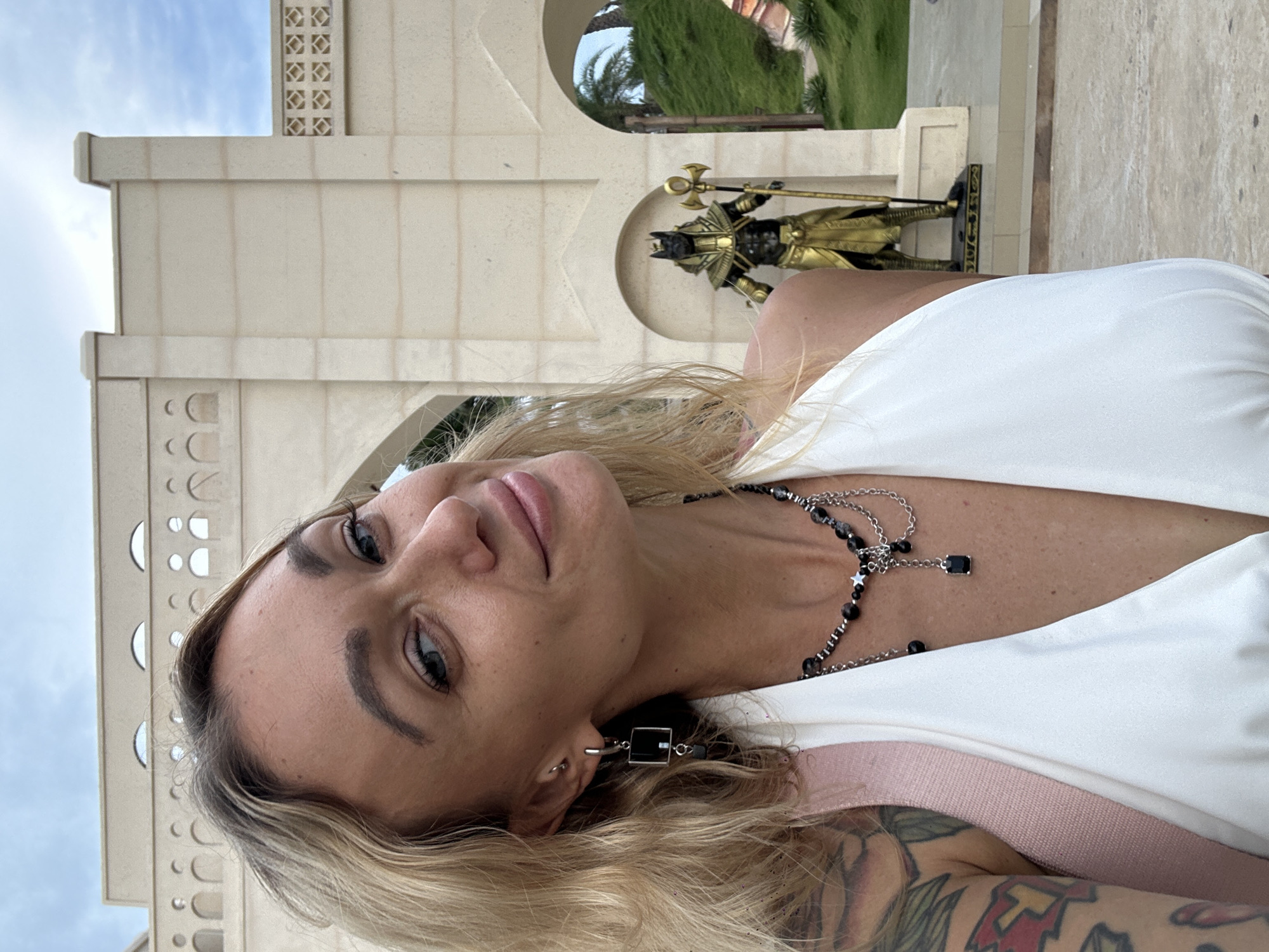 Tourist photographs herself at Egyptian-themed archway in Mũi Né