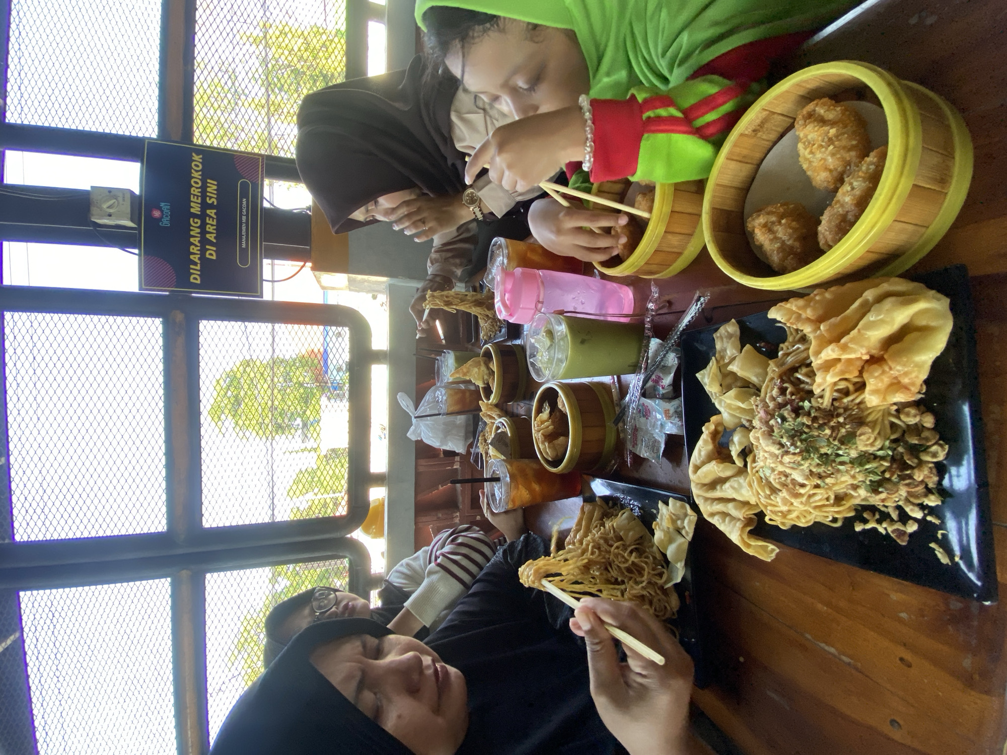 Family shares noodle meal at Indonesian restaurant in Candi
