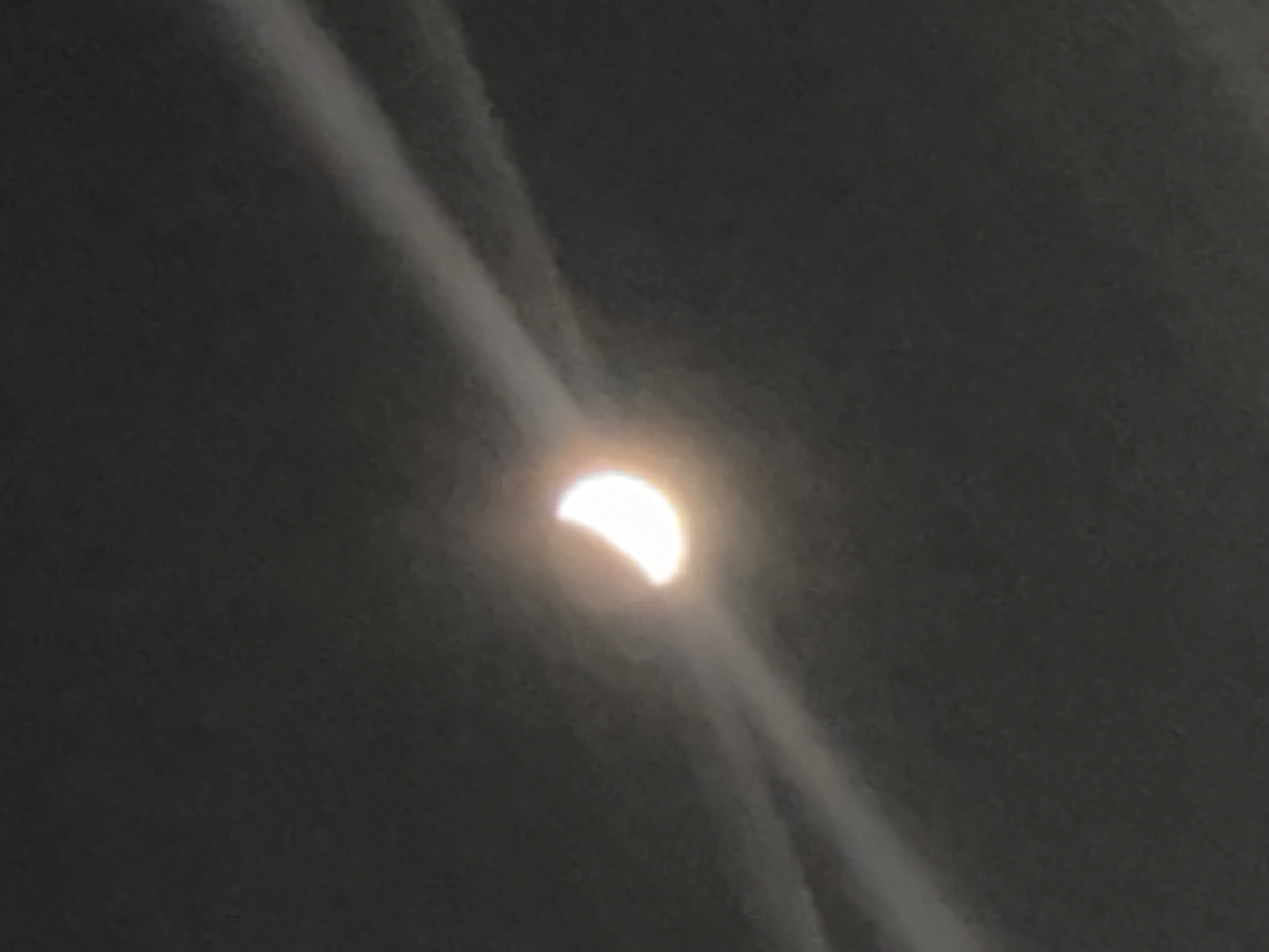 Crescent celestial object observed during apparent partial eclipse event