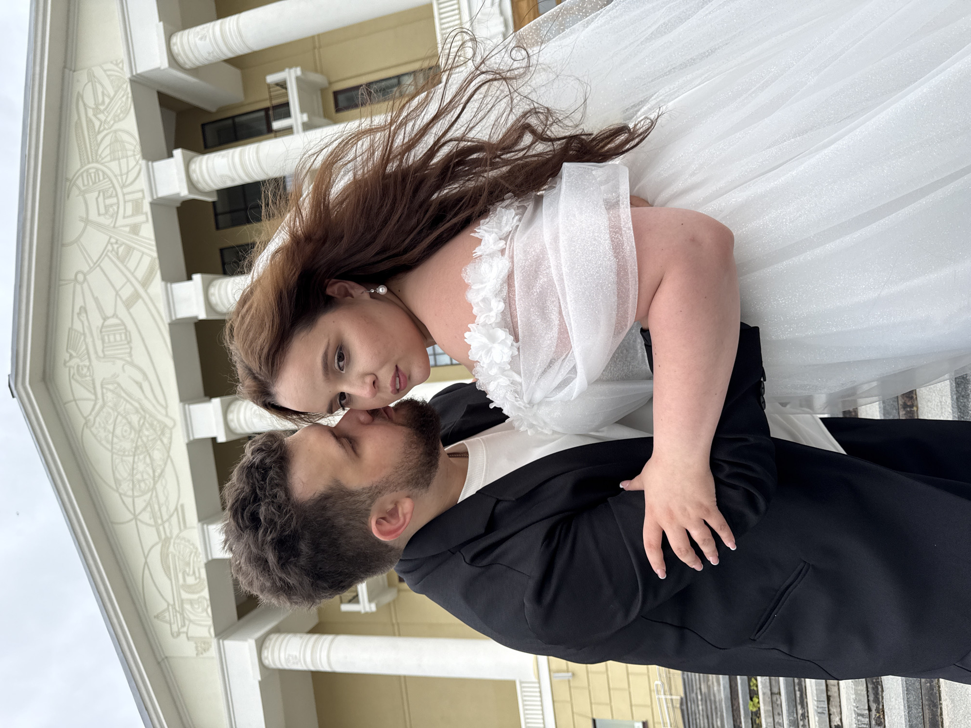 Wedding portraits on a classical building's steps in Votkinsk