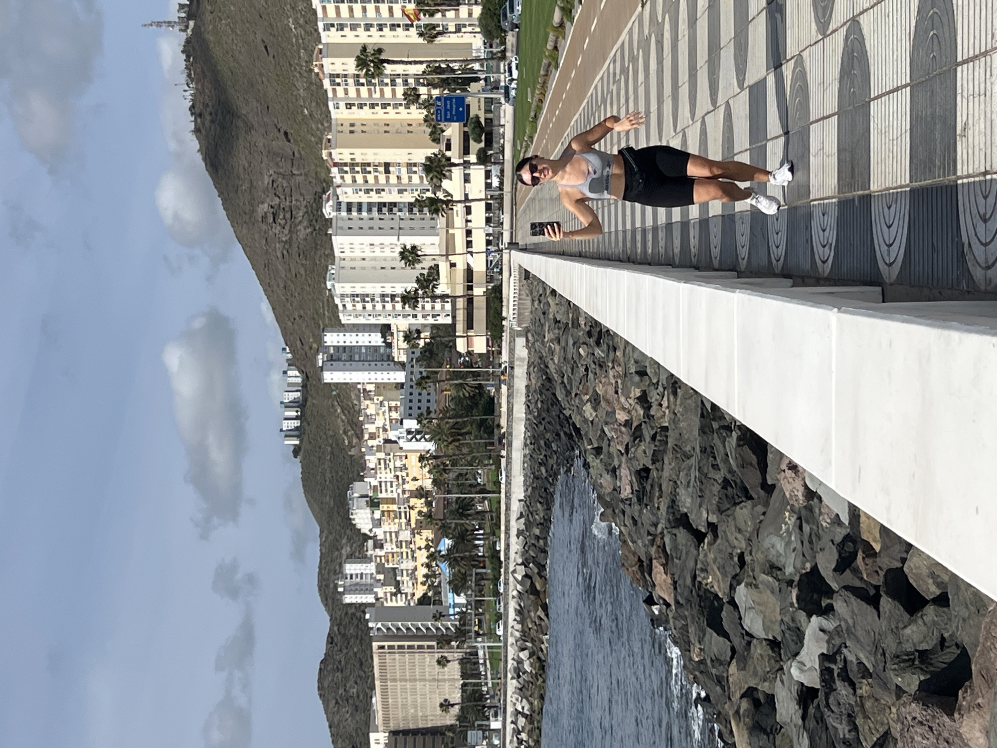 Woman takes selfies along Las Palmas waterfront walkway
