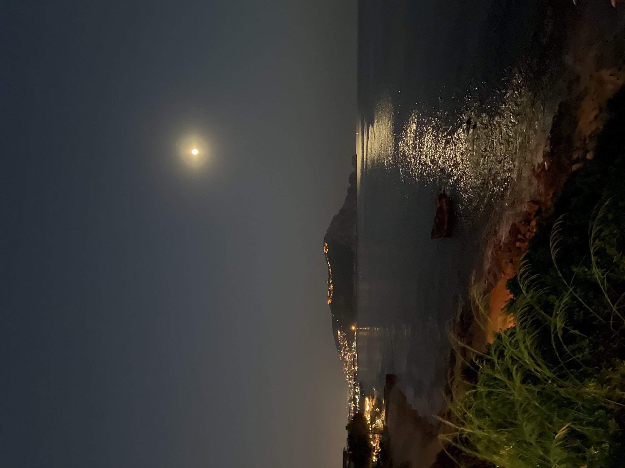Full moon rising over the Alanya coastline at dusk
