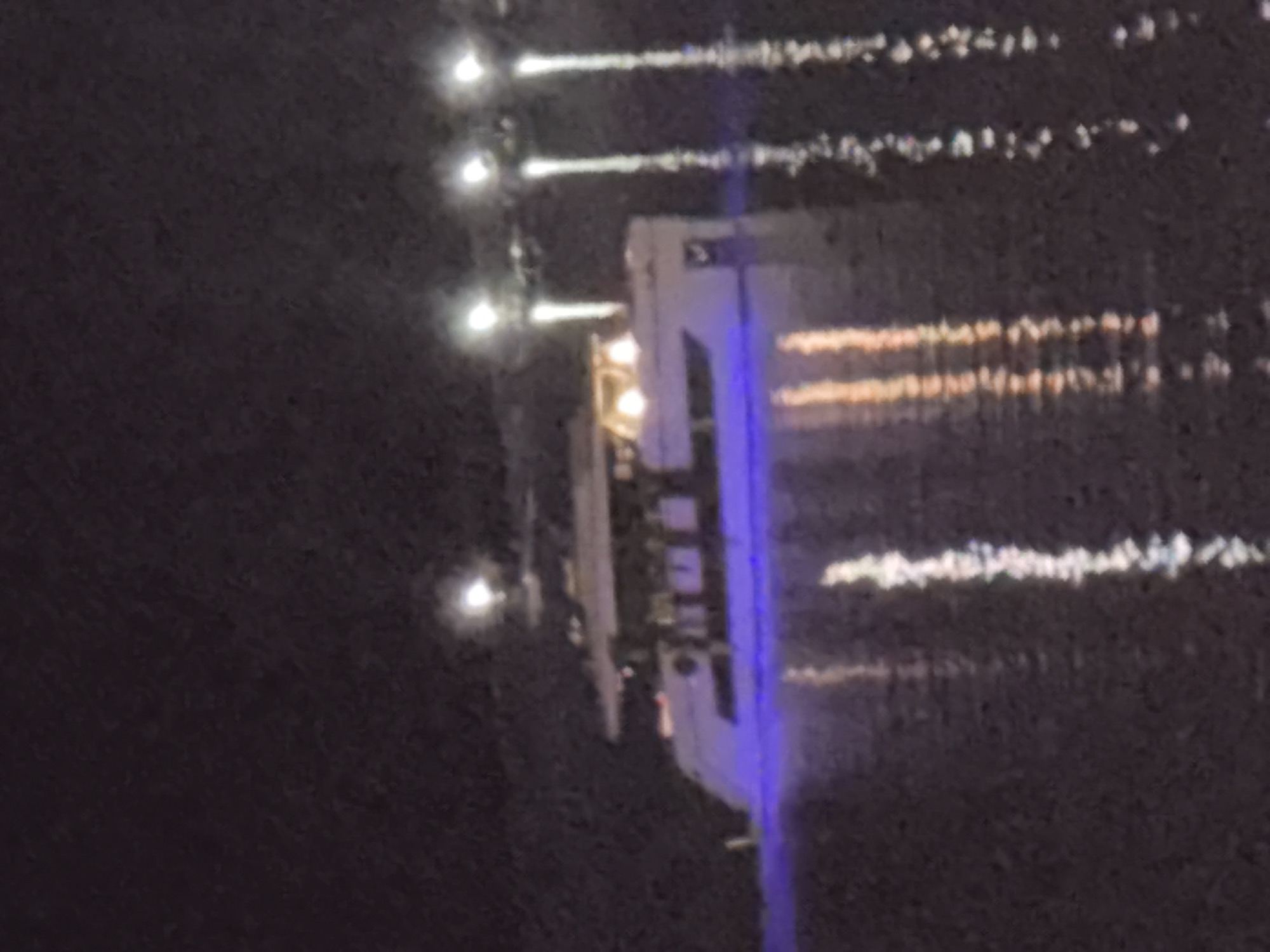Budva waterfront at night — yachts, coastline, and resort life
