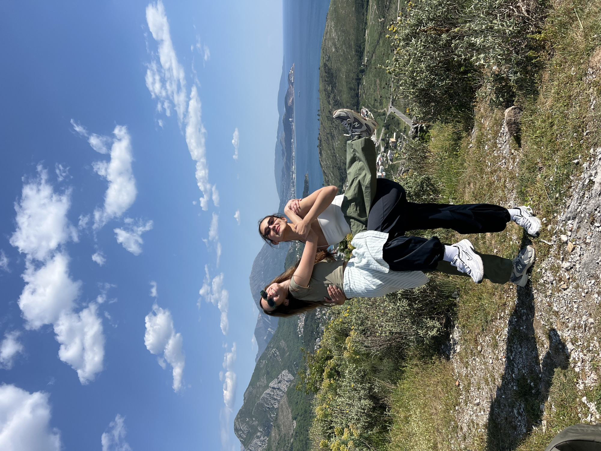 Women photograph scenic coastal visit in Sutomore, Montenegro