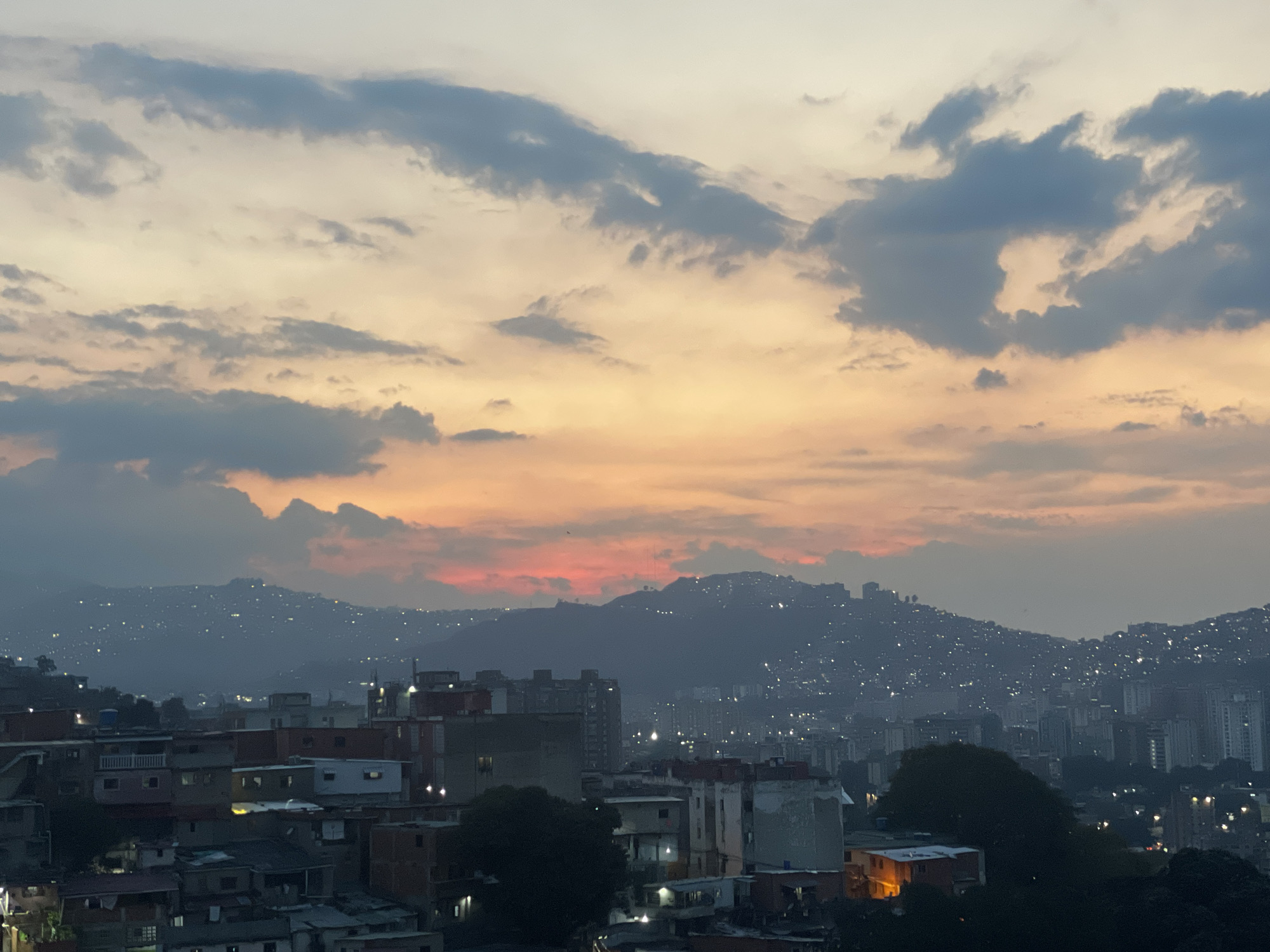Dusk skyline captured over Caracas mountain cityscape
