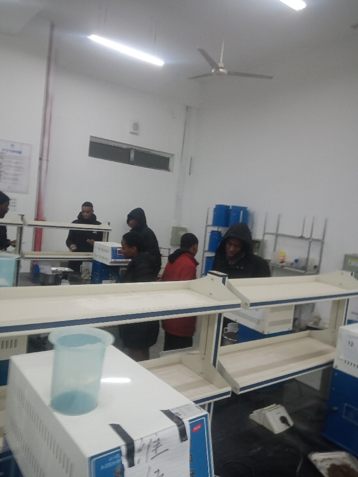 Late-night laboratory work session with cement testing equipment observed