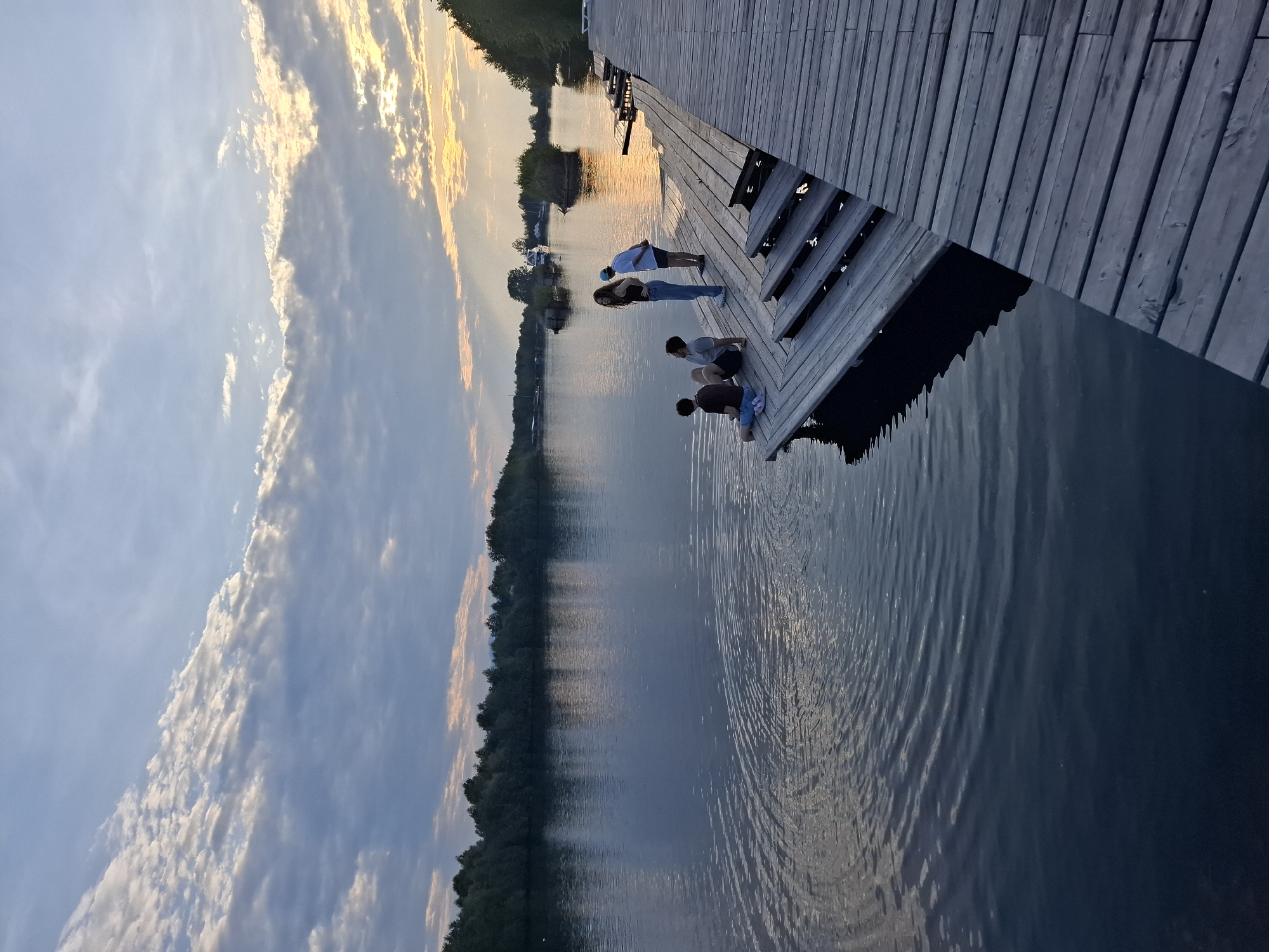 Sunset at a lakeside dock near Vydrino's mountain shoreline