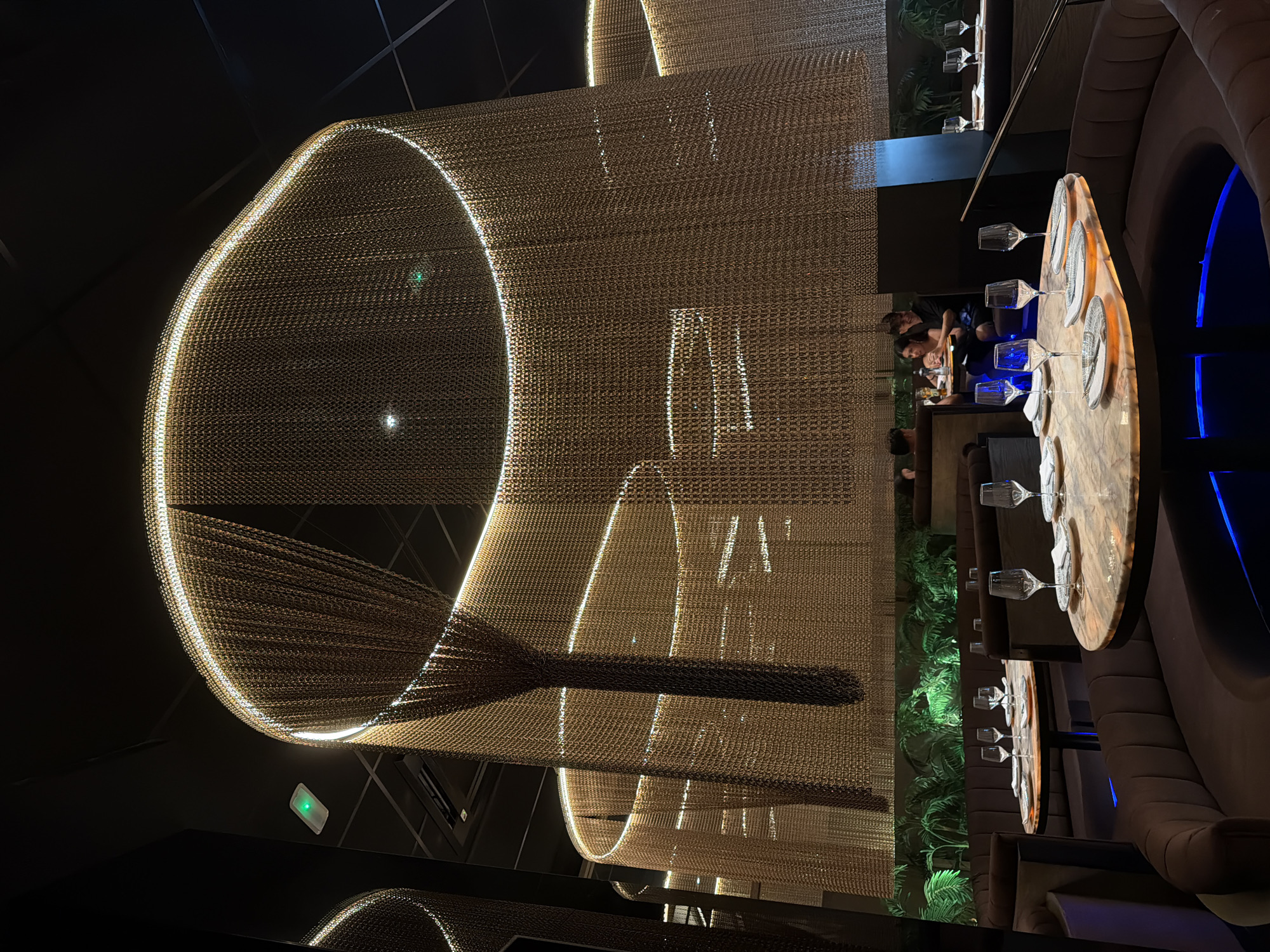 Inside an upscale Almería restaurant with chain-link curtain decor